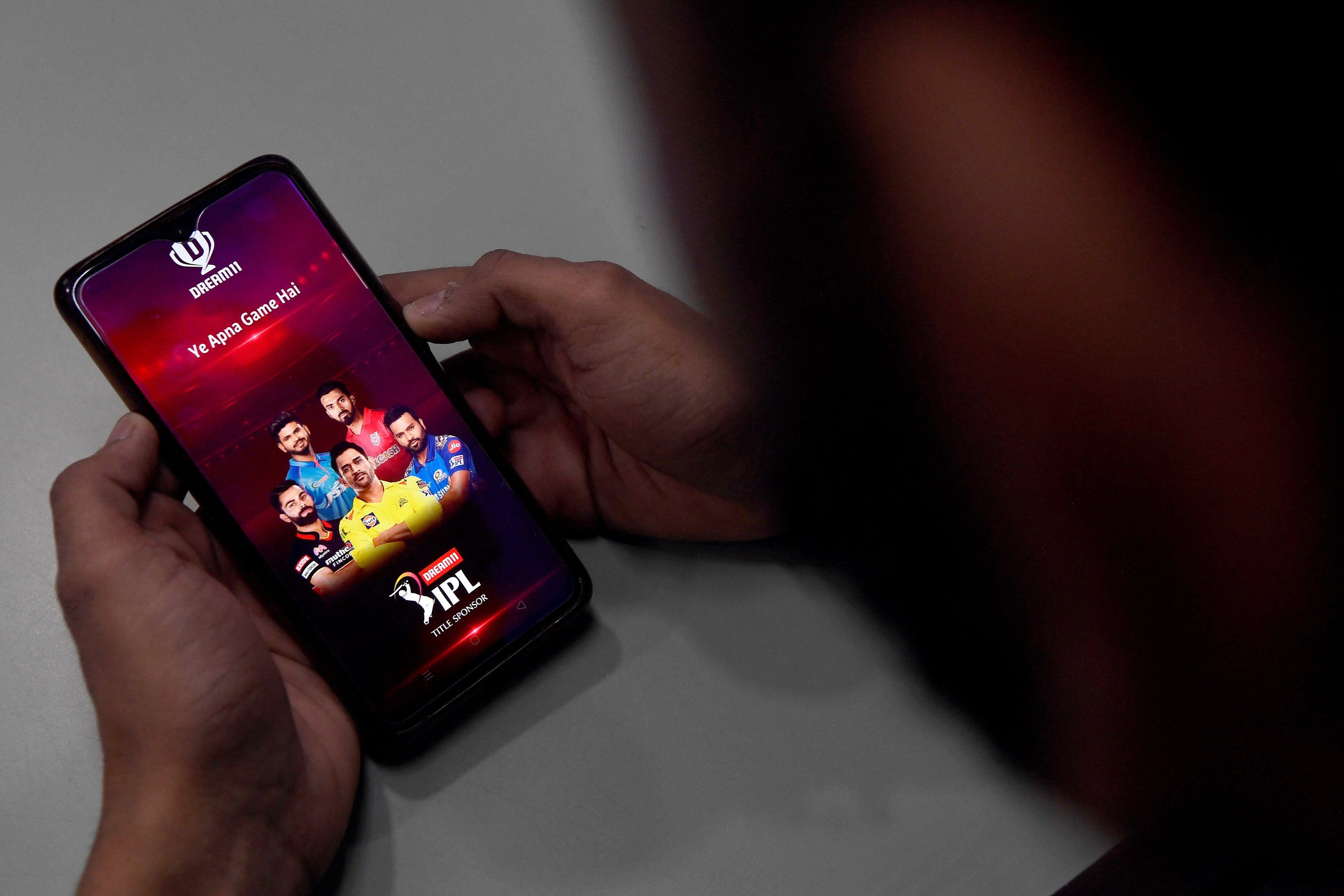 A user checks the Dream11 application of the Indian Premier League cricket tournament