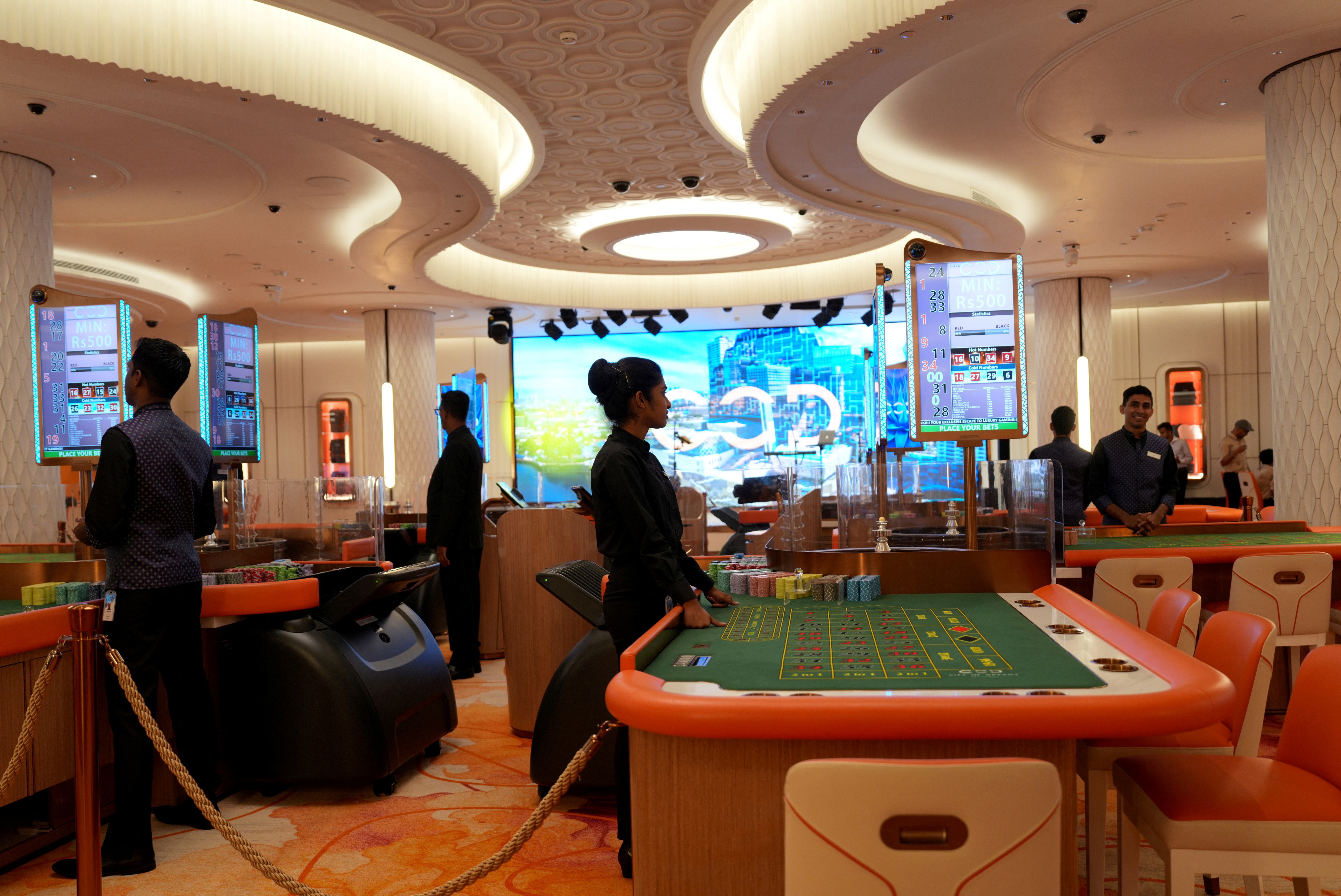 Employees stand inside a casino at City of Dreams, an integrated resort that includes Sri Lanka's first high end casino, in Colombo, Sri Lanka