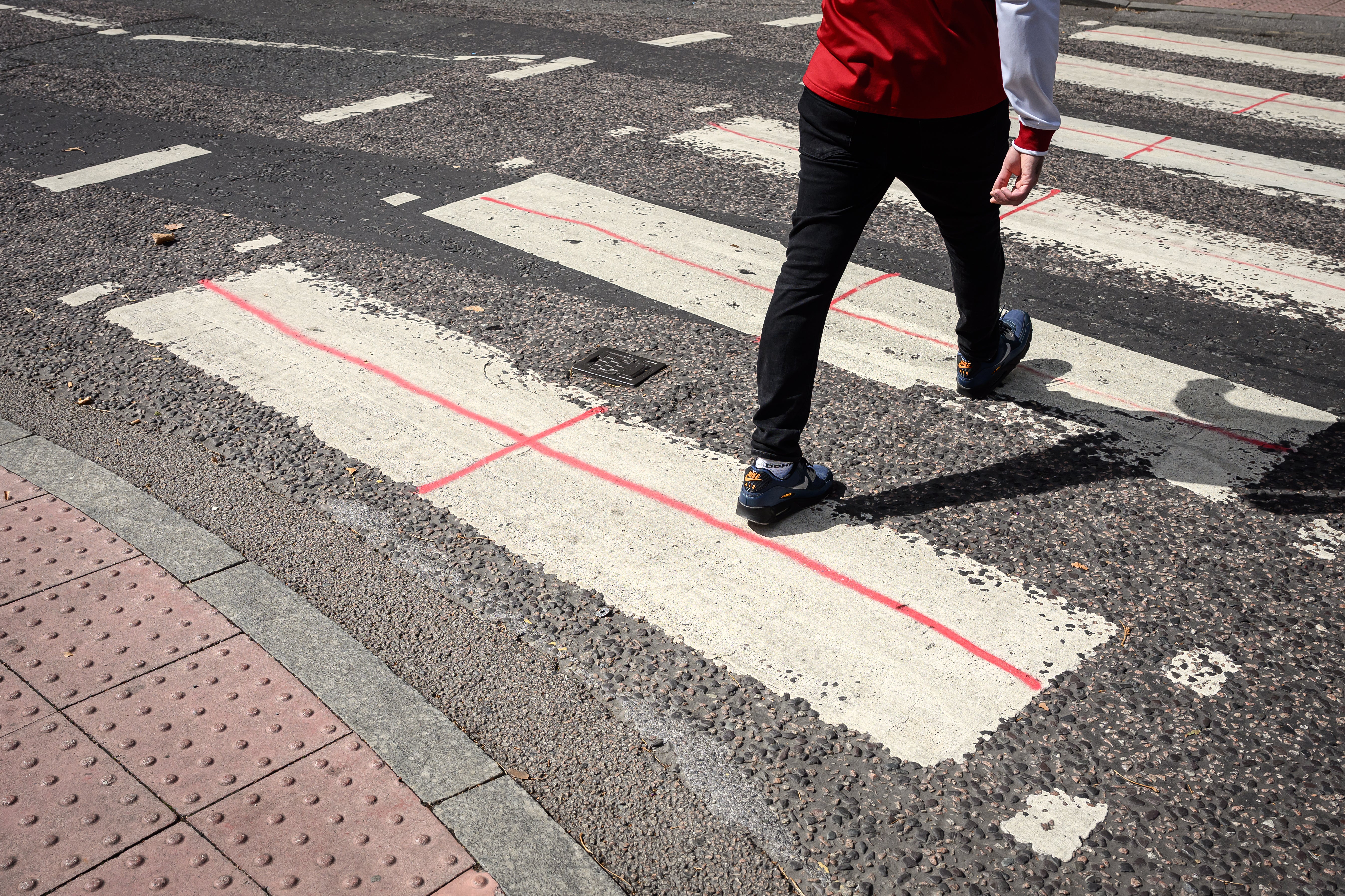 A pedestrian crossing near a migrant hotel in London was among those daubed