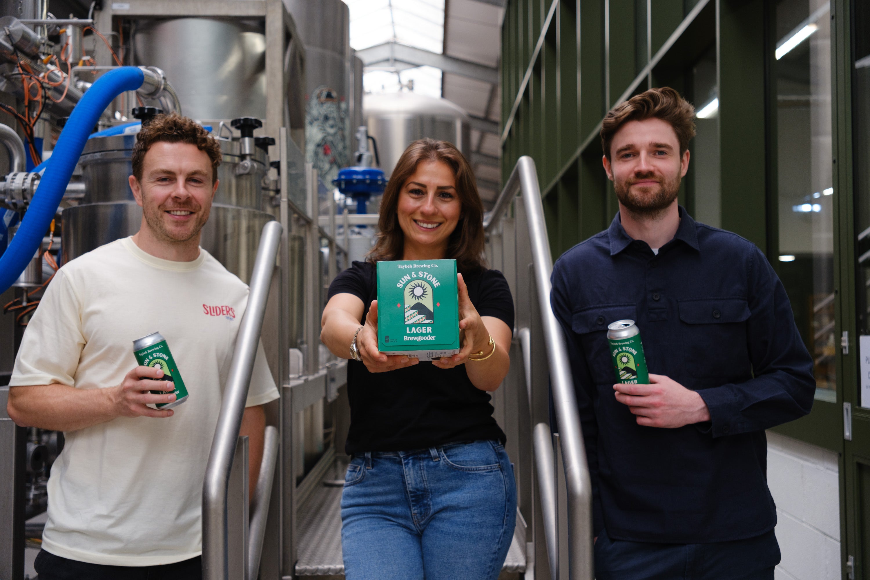 <p>Madees Khoury (centre) with Brewgooder co-founders Alan Mahon (left) and James Hughes (right) (Brewgooder/PA)</p>