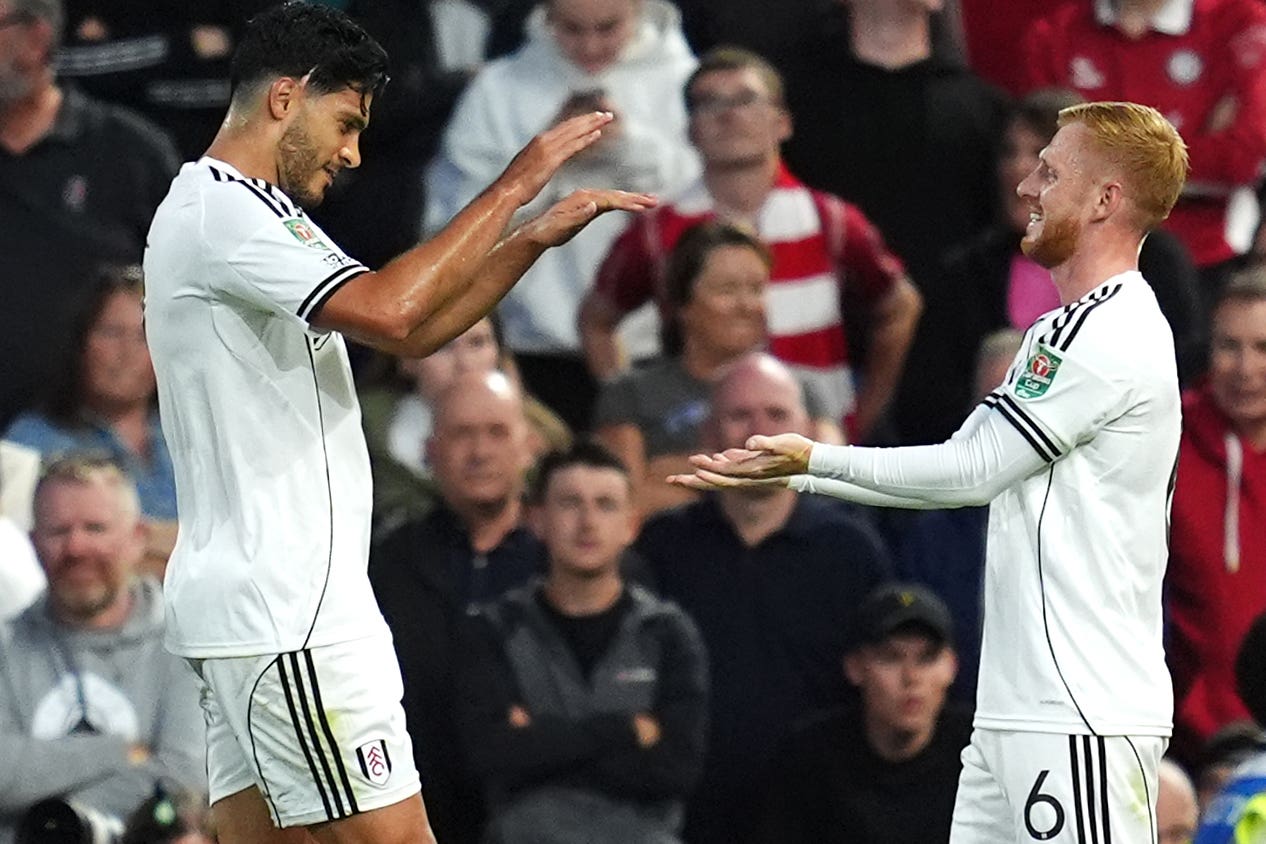 Raul Jimenez (left) was on target for Fulham as they reached the third round
