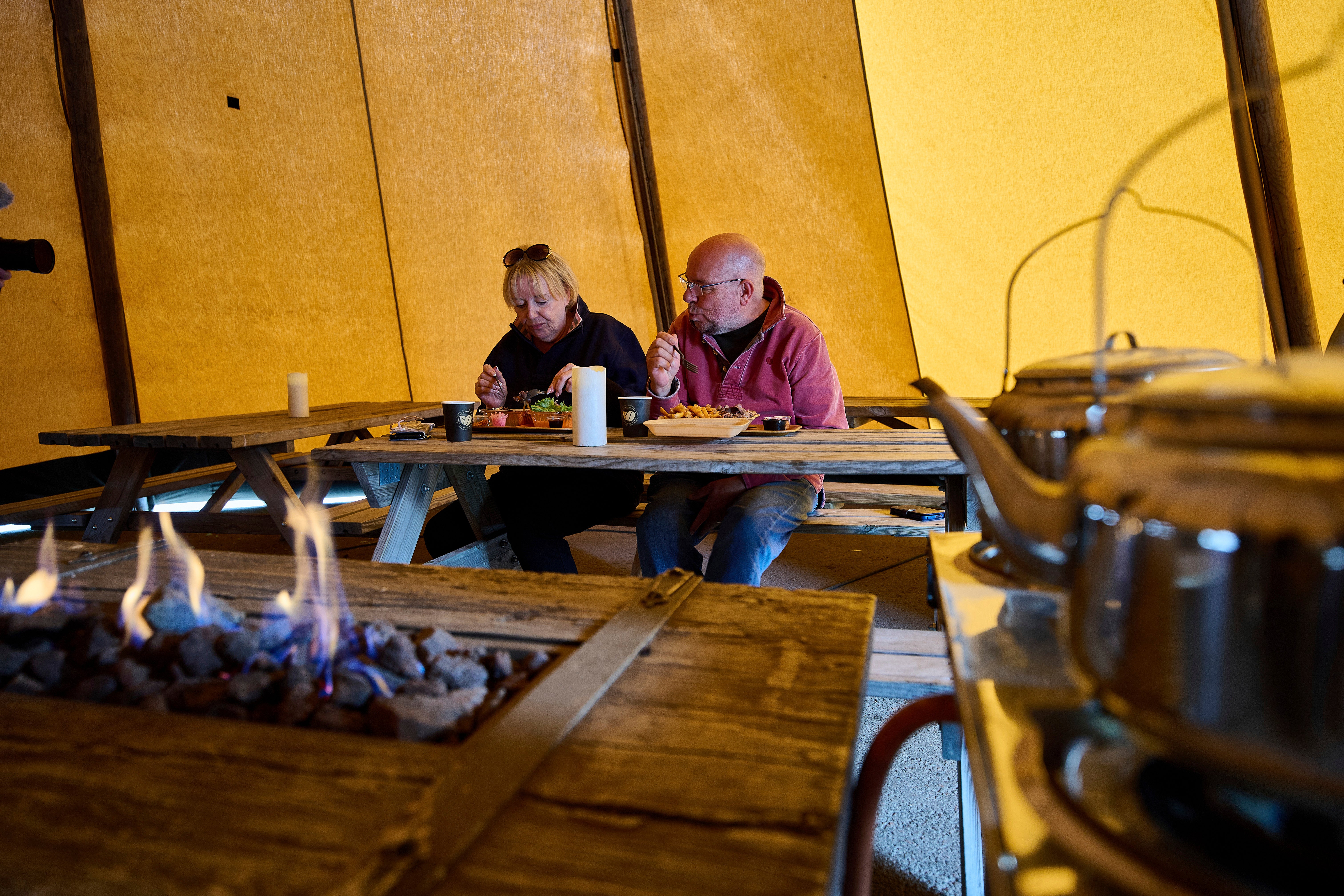 Anita and Don Haymes eat at the Stejk Street Food food truck in Kiruna, Sweden, Sunday, Aug. 17, 2025. (AP Photo/Malin Haarala)
