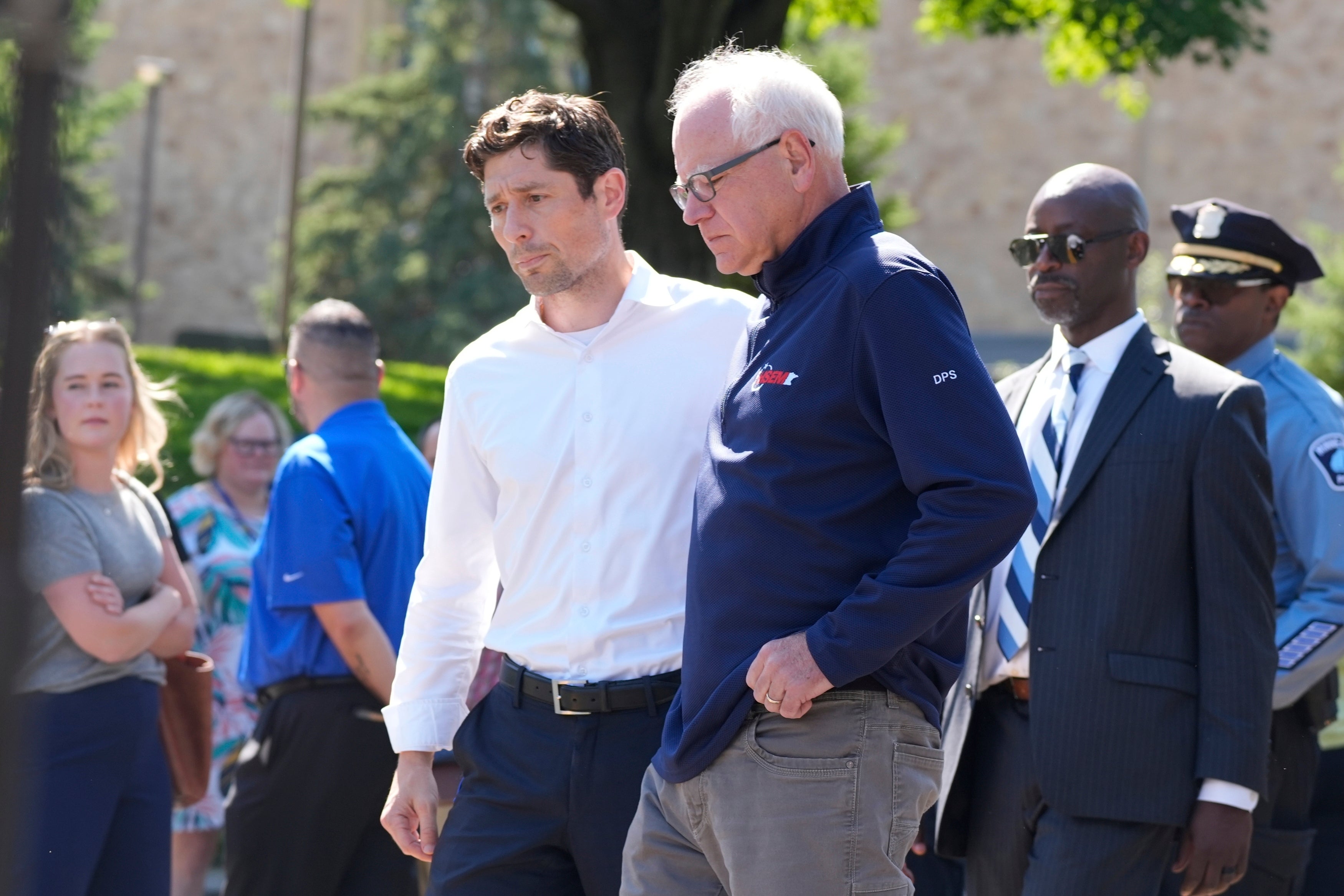 Minneapolis mayor Jacob Frey walks with Gov. Tim Walz at the site of a mass shooting at a Catholic school in Minnesota