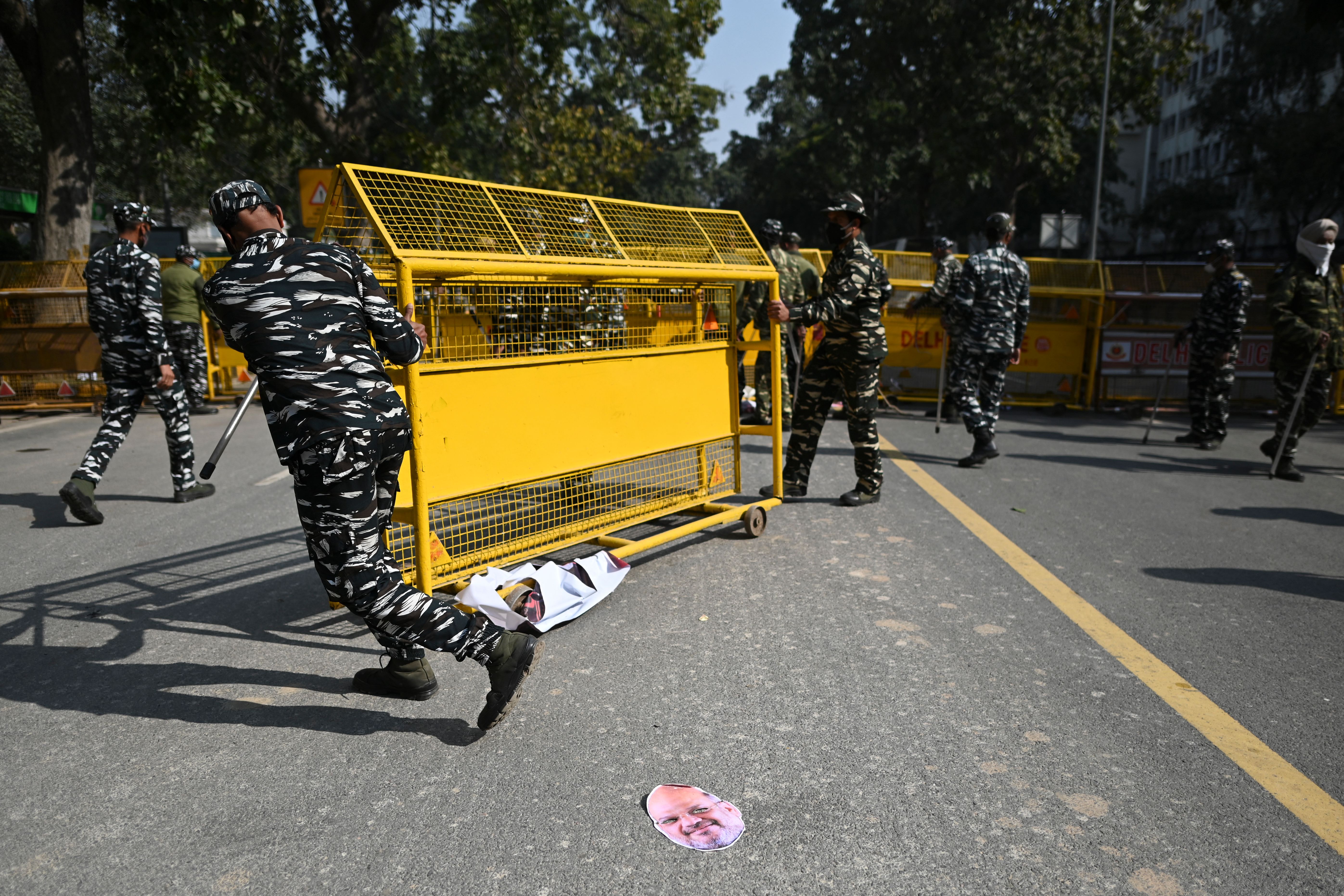 Representative. Police personnel move barricades in Delhi