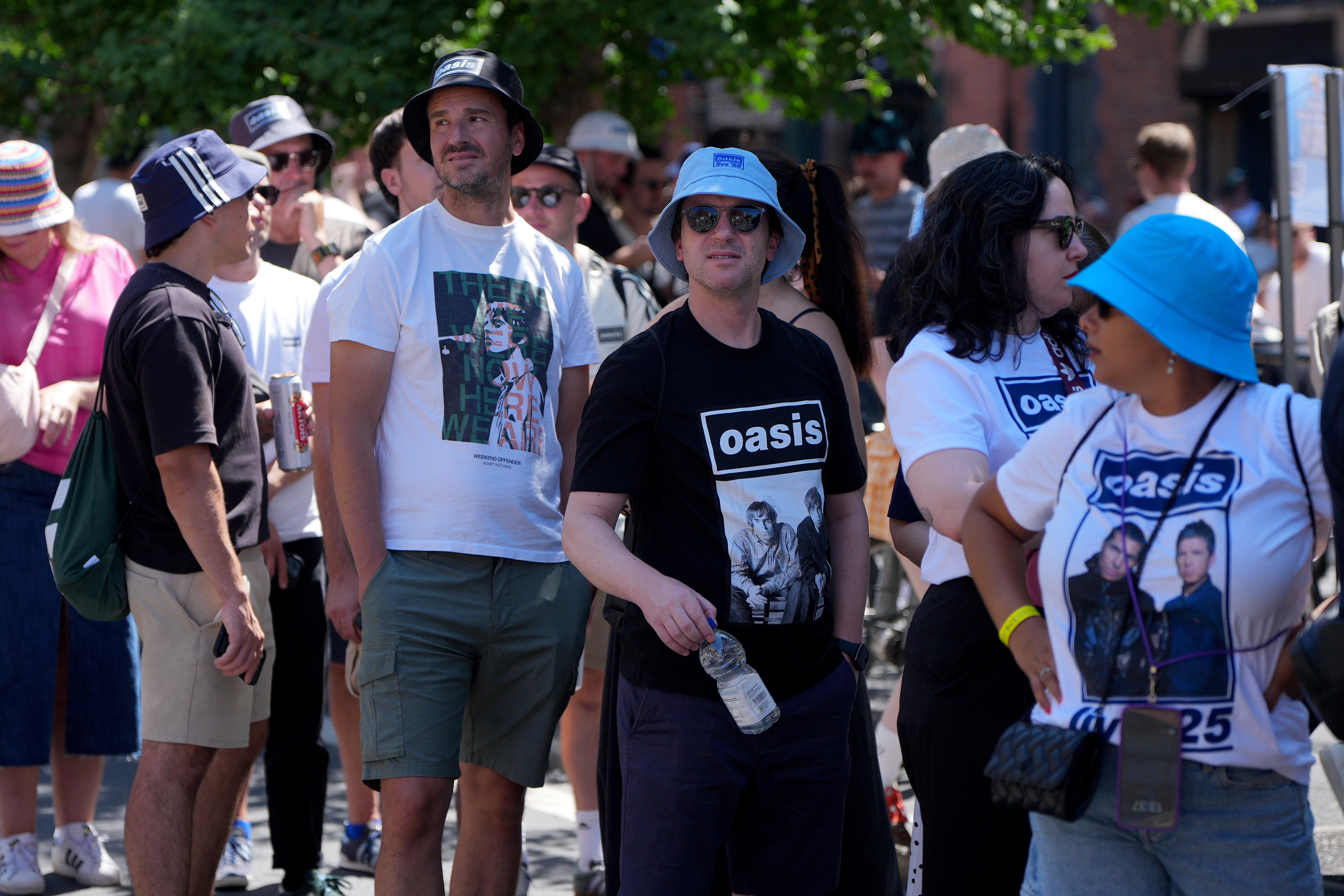 Concertgoers show off the obligatory band tees ahead of Oasis’s reunion concert in Heaton Park, Manchester