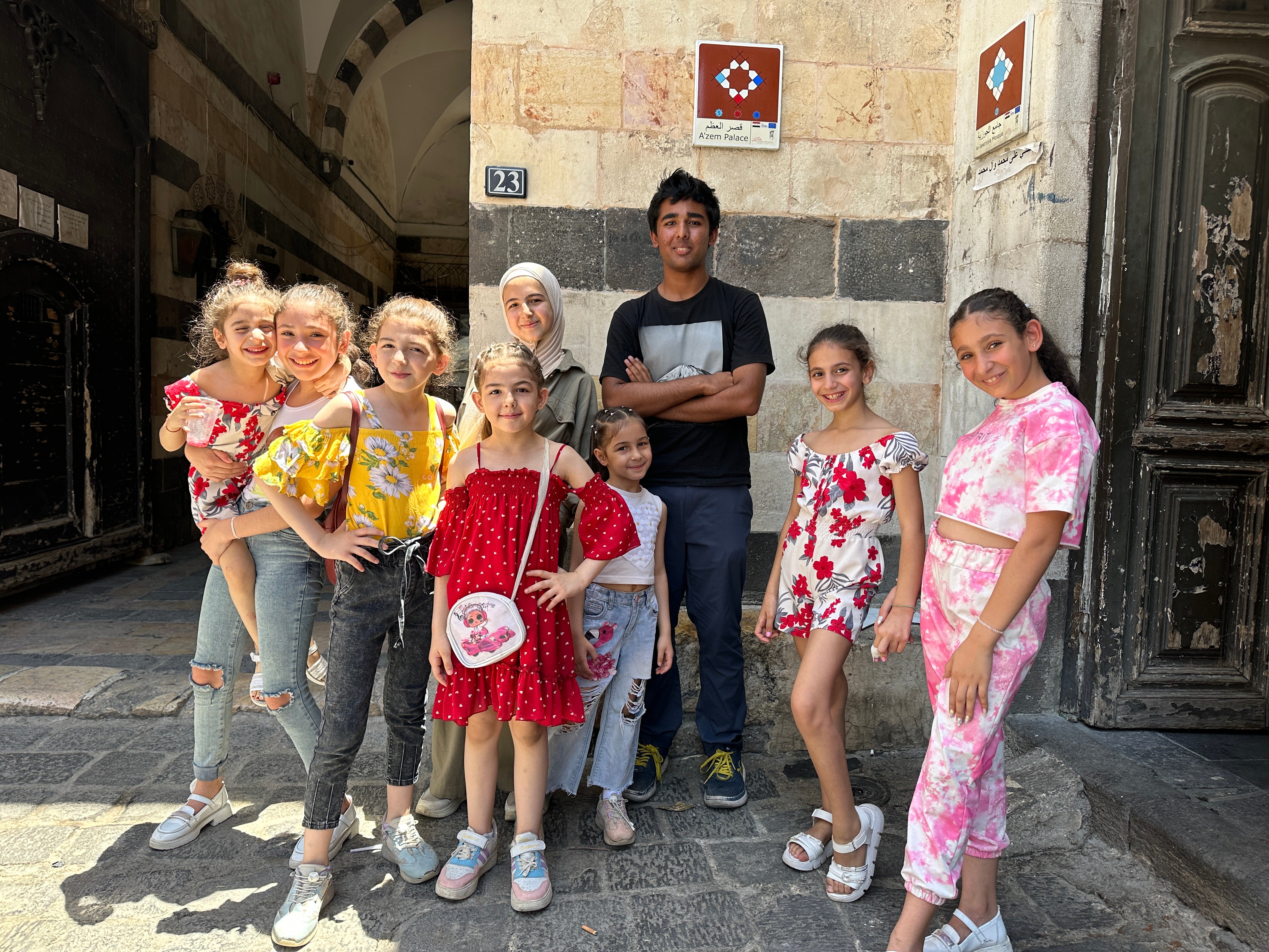 Arjun with local schoolgirls in Damascus, Syria.