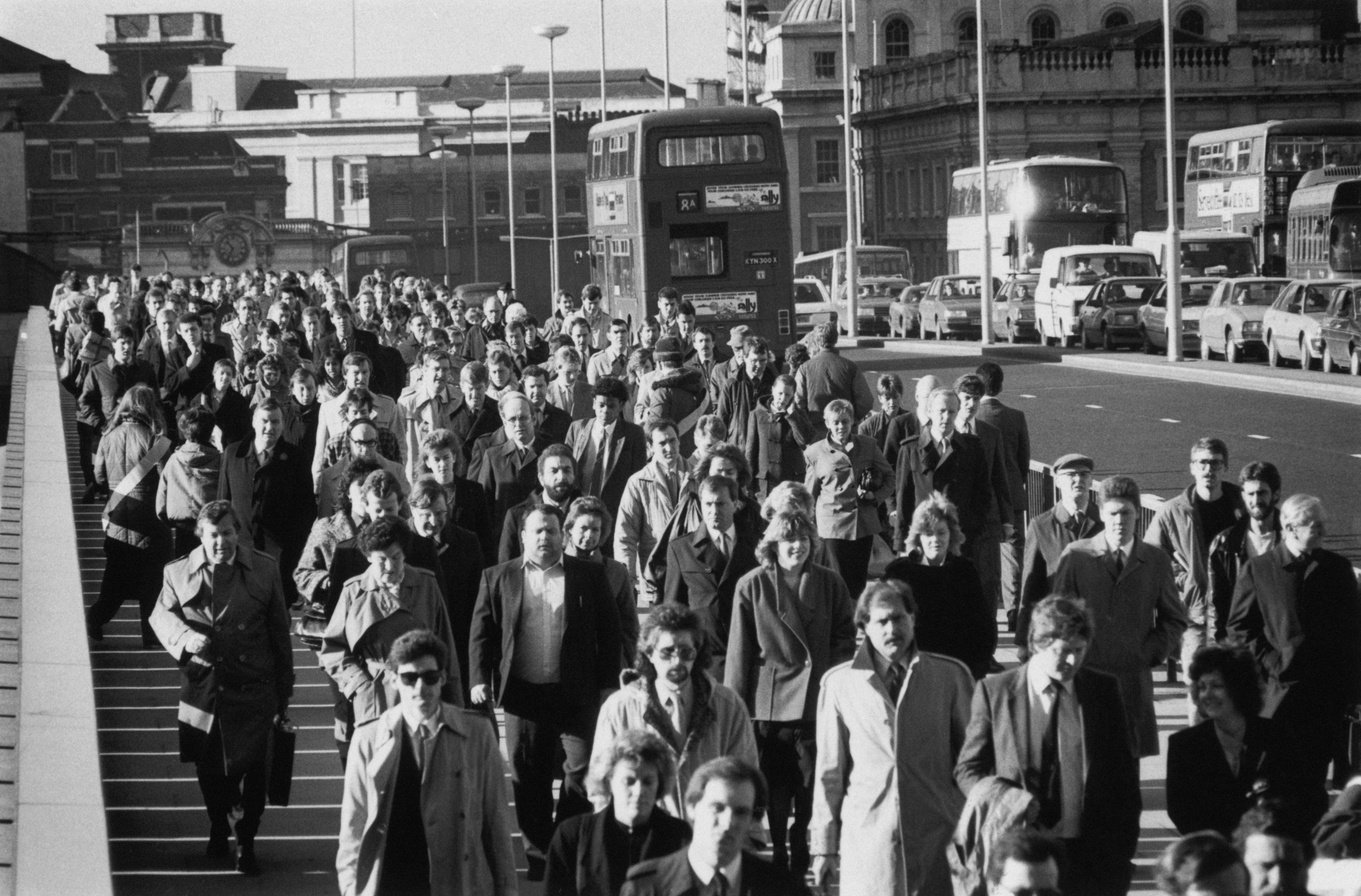 City workers crossing London Bridge during rush hour in 1987