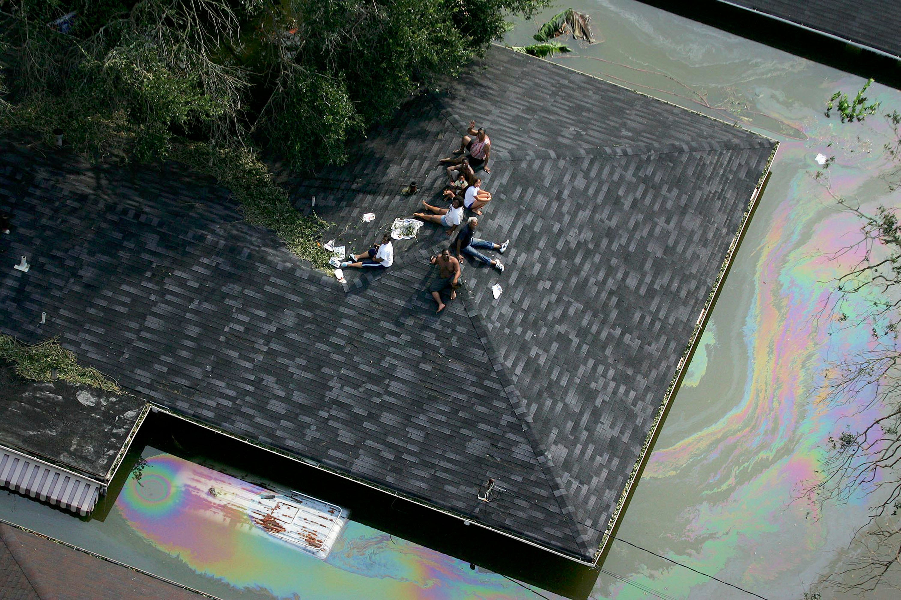 People are stranded on a New Orleans roof due to flood waters from Hurricane Katrina. It took weeks for the floodwaters to be fully removed from the city