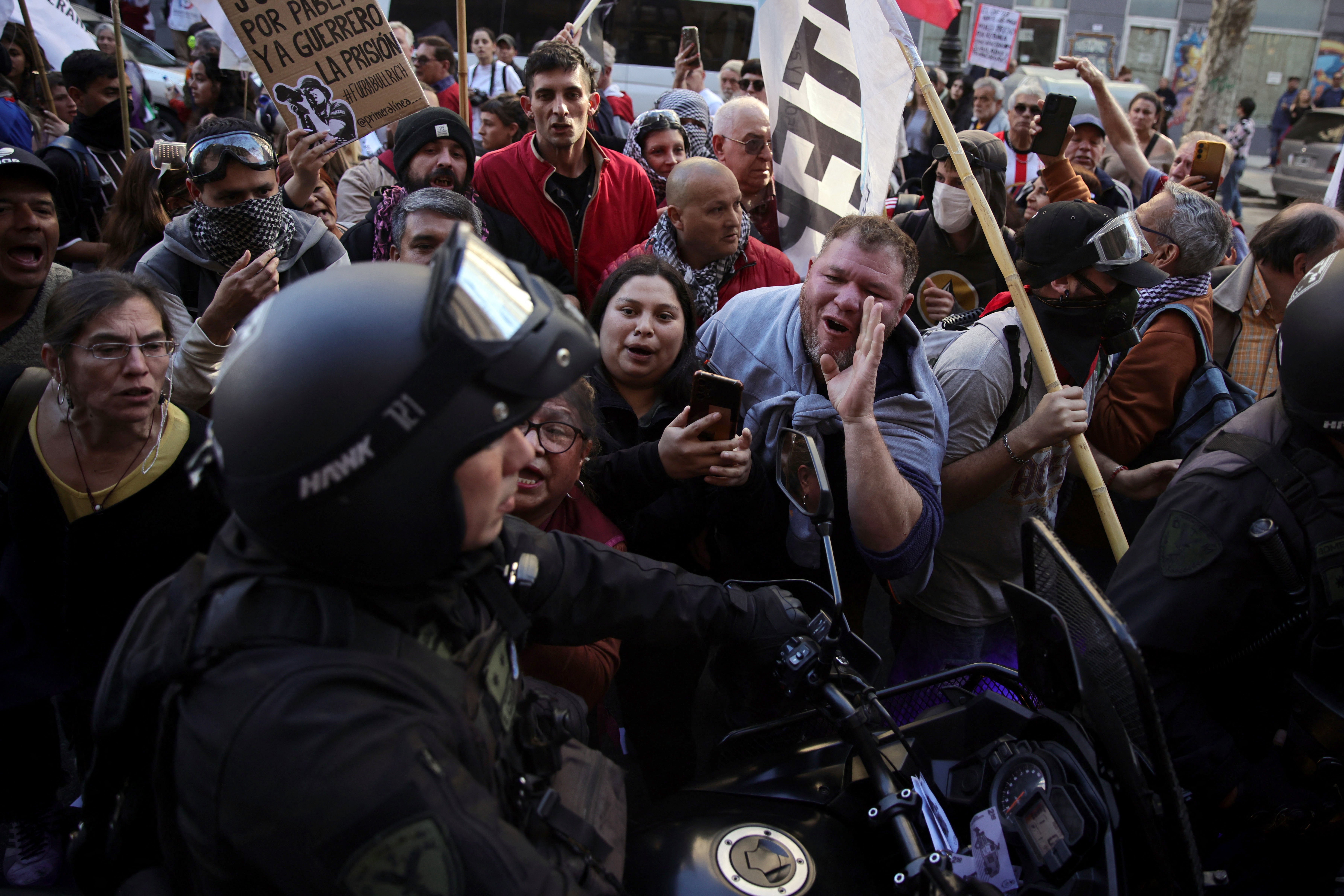Protesters shout at a riot police officer during a demonstration by retirees and pensioners against the economic policies of Javier Milei's government in Buenos Aires on 27 August 2025