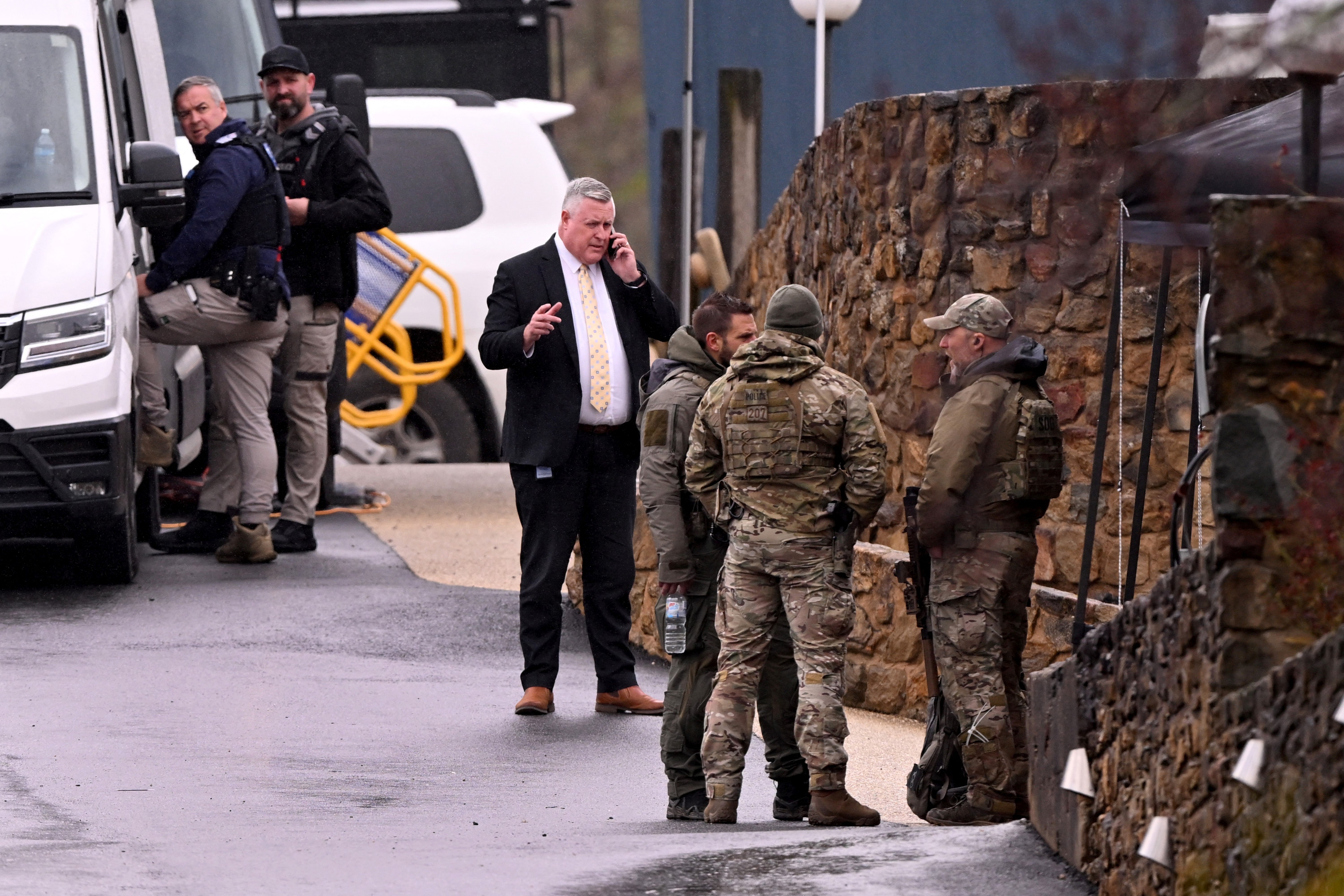 Heavily armed police gather at a police staging point during the search for a fugitive linked to the murder of two police officers, in Porepunkah on 28 August 2025