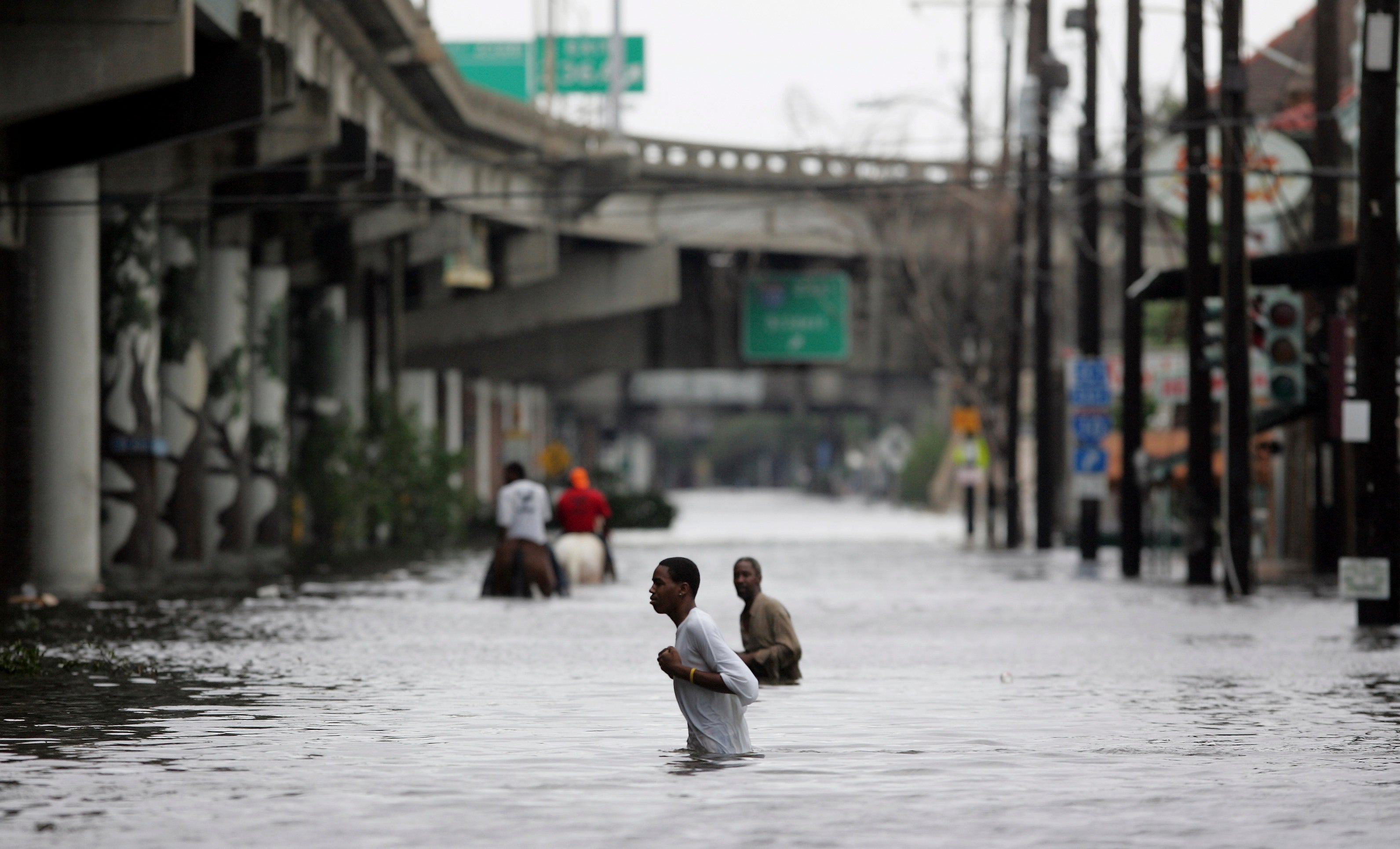New Orleans residents walk through chest deep floodwaters after Hurricane Katrina. It’s been 20 years since the storm hit the Louisiana coast
