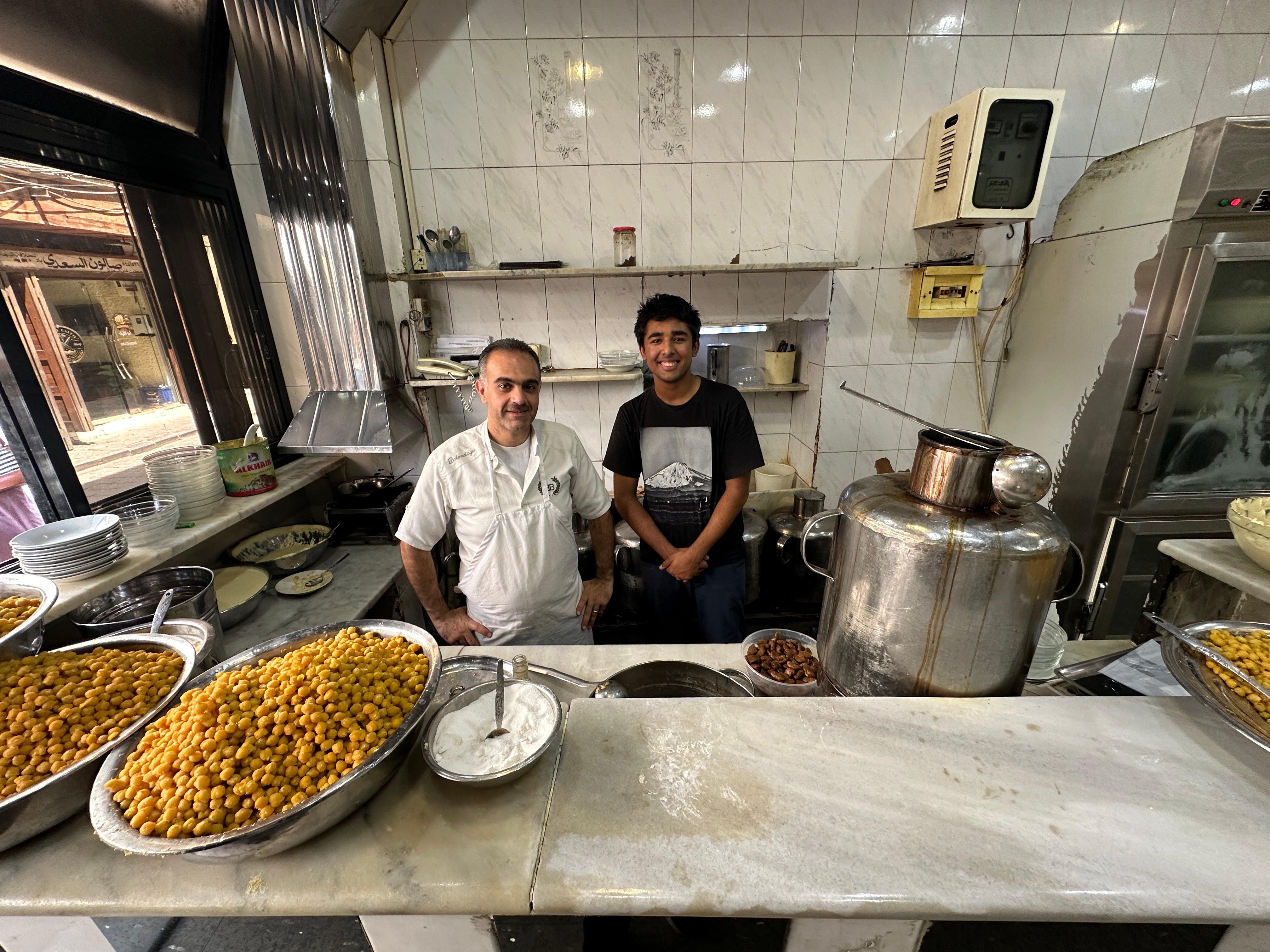 Arjun with a local restaurant owner in Damascus, Syria.