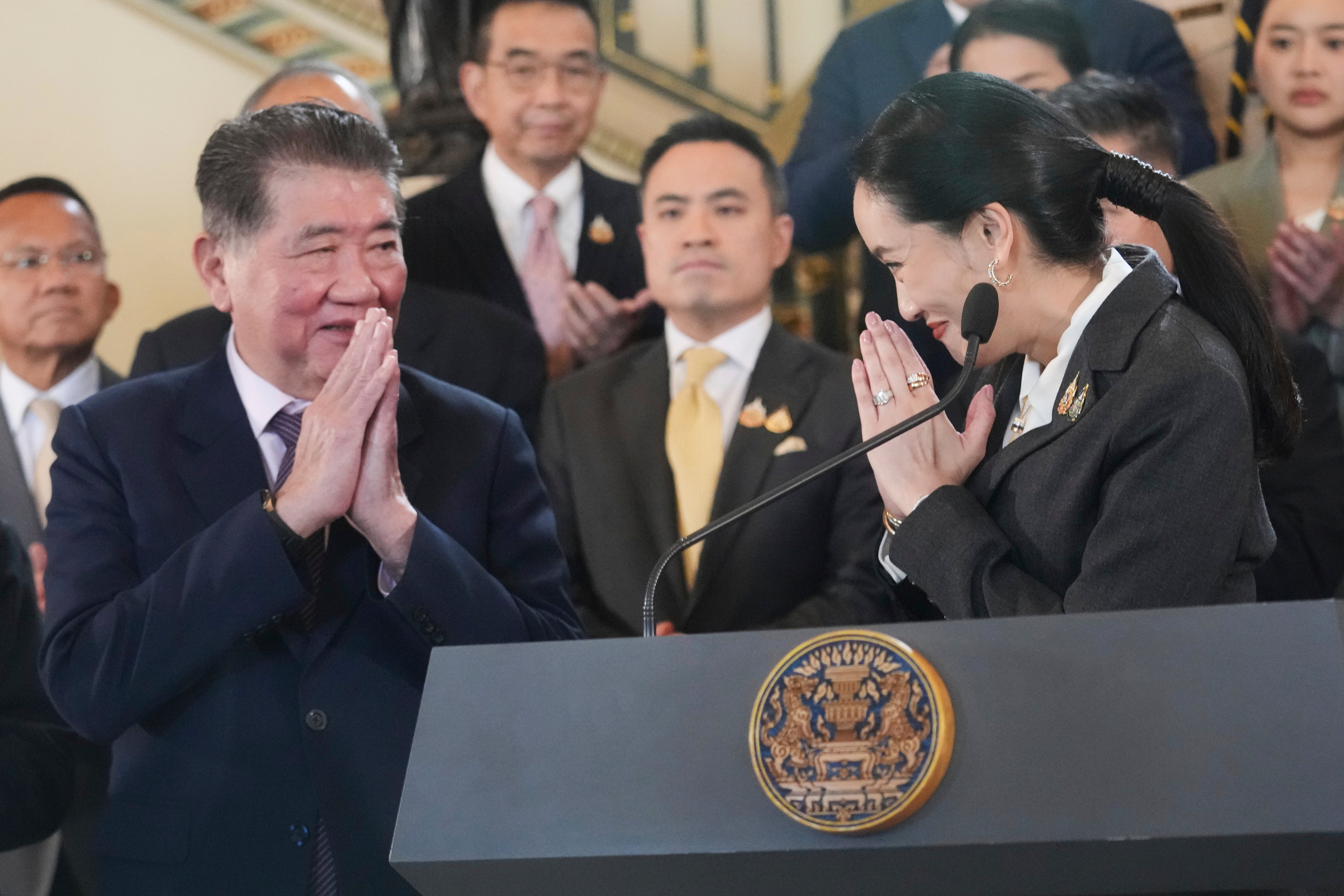 Thailand's suspended prime minister Paetongtarn Shinawatra, right, gestures at former acting prime minister Phumtham Wechayachai during a press conference after her dismissal, in Bangkok, Thailand
