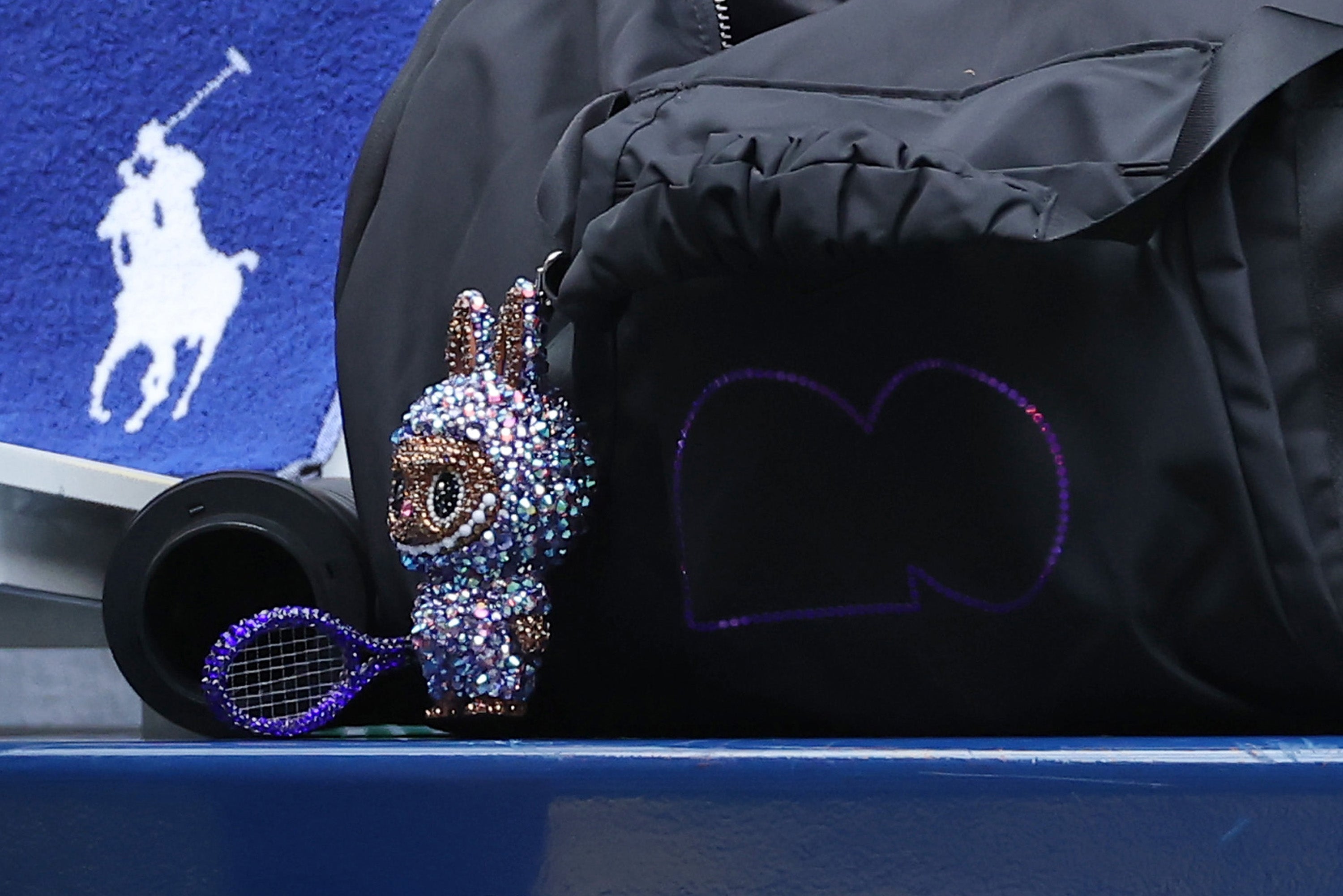 Osaka is also following Gen Z’s latest trend: Attaching a Labubu doll to her bag. Her fuzzy monster was covered in purple and blue jewels, with a tennis racket in hand