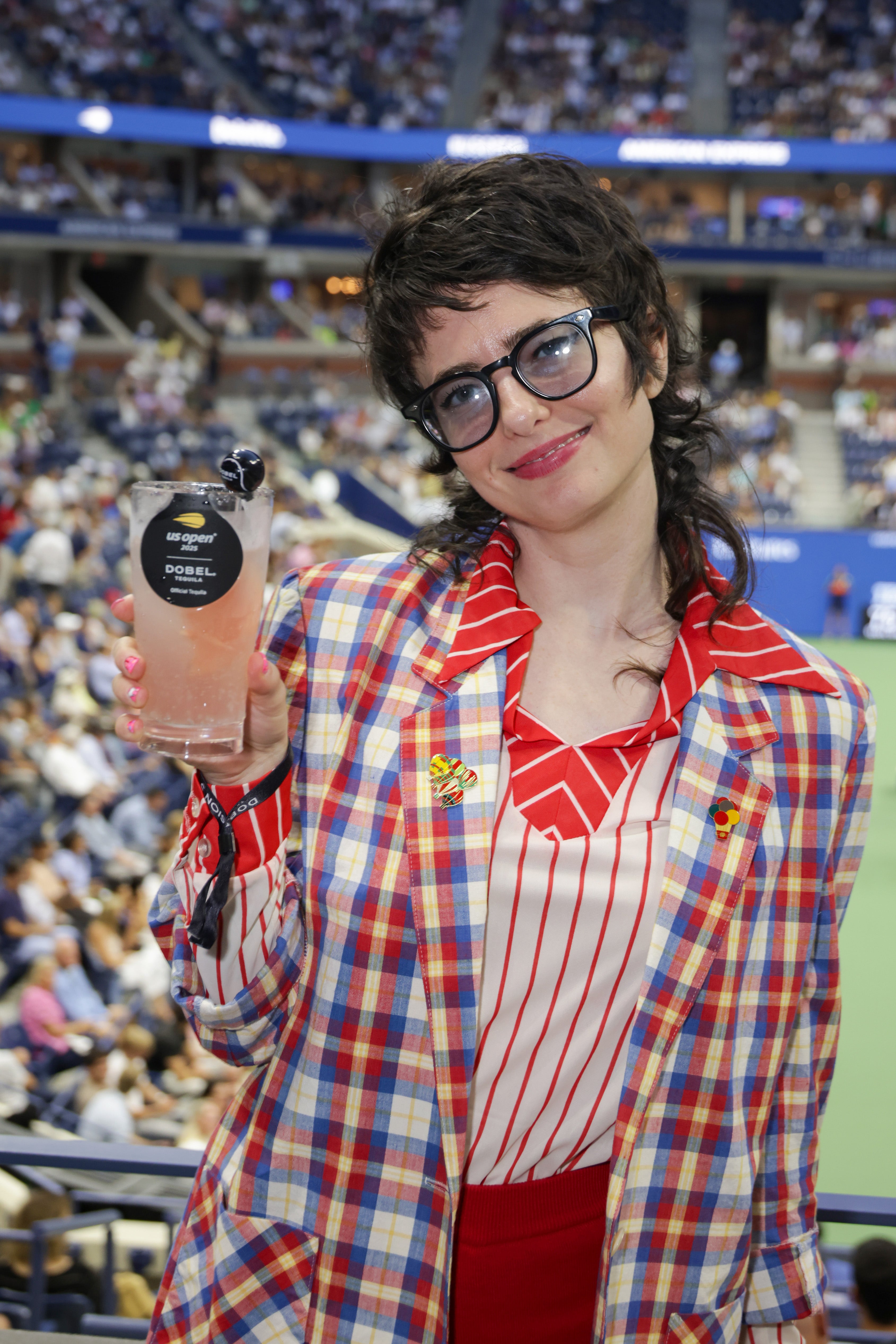 ‘Saturday Night Live’ star Sarah Sherman went for bright colors and stripes, but her two red-striped shirts paired with a checkered, multi-colored jacket ended up clashing rather than complementing