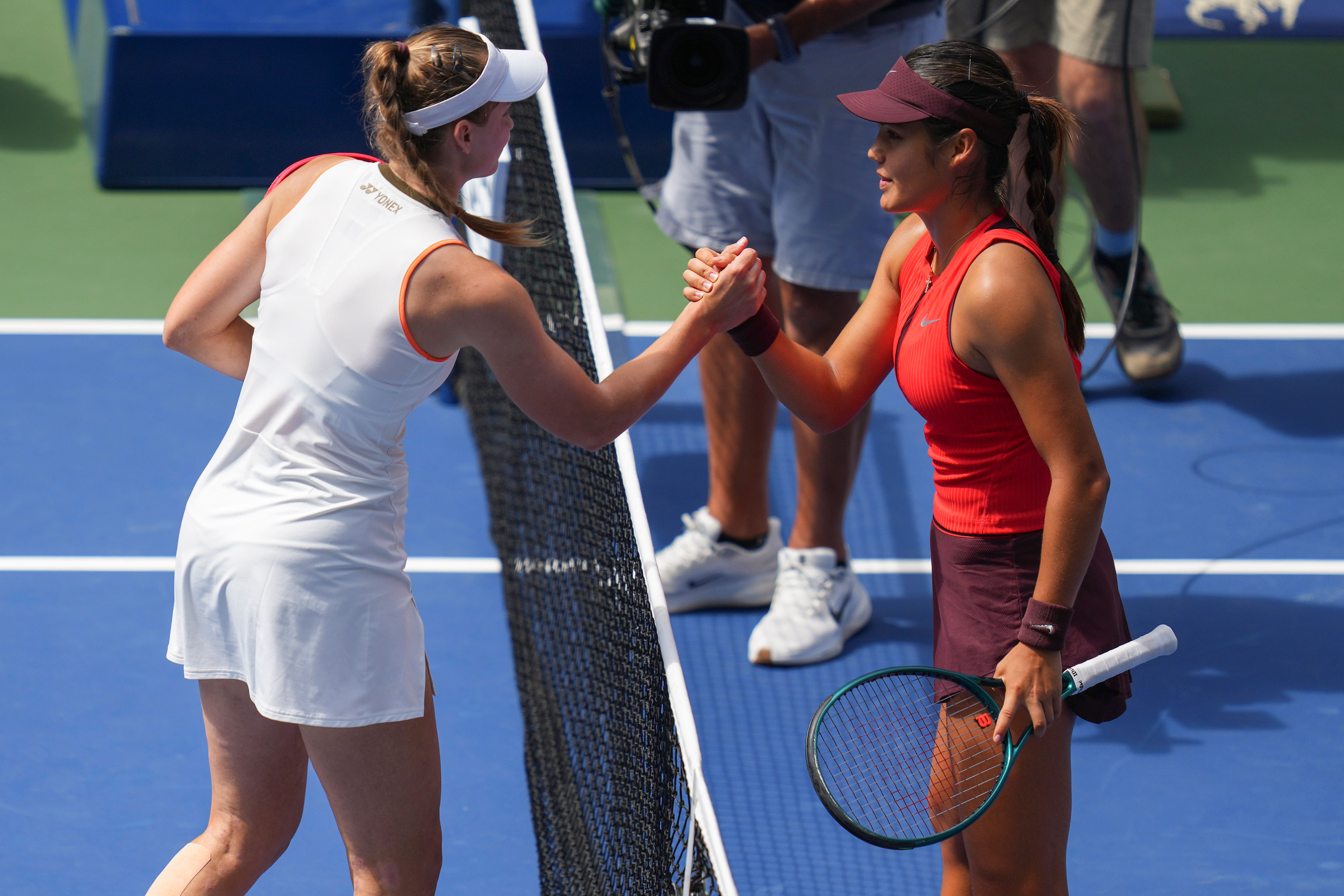 Emma Raducanu, right, shakes hands with Elena Rybakina (Kirsty Wigglesworth/AP)