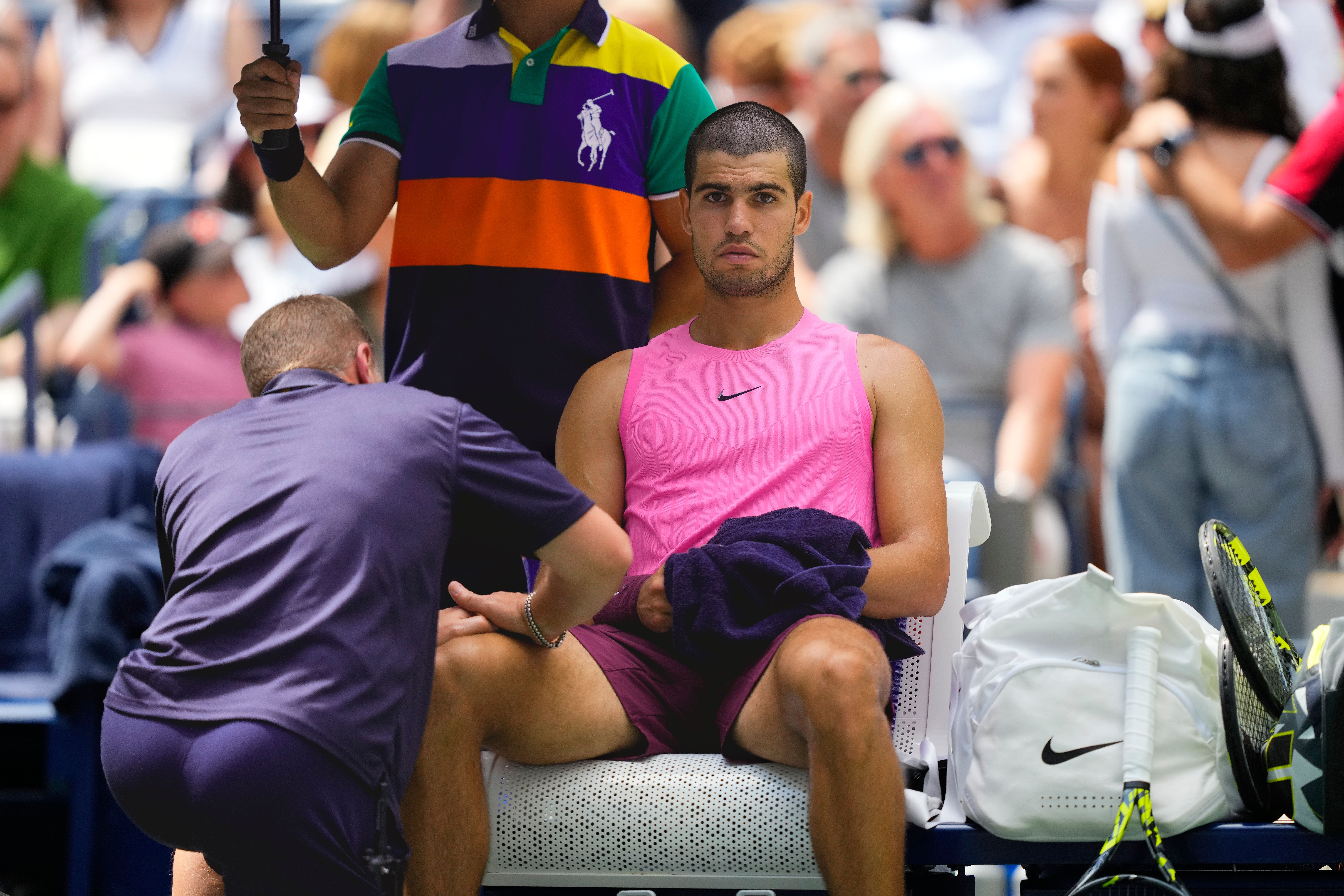 A trainer treats Carlos Alcaraz (Yuki Iwamura/AP)