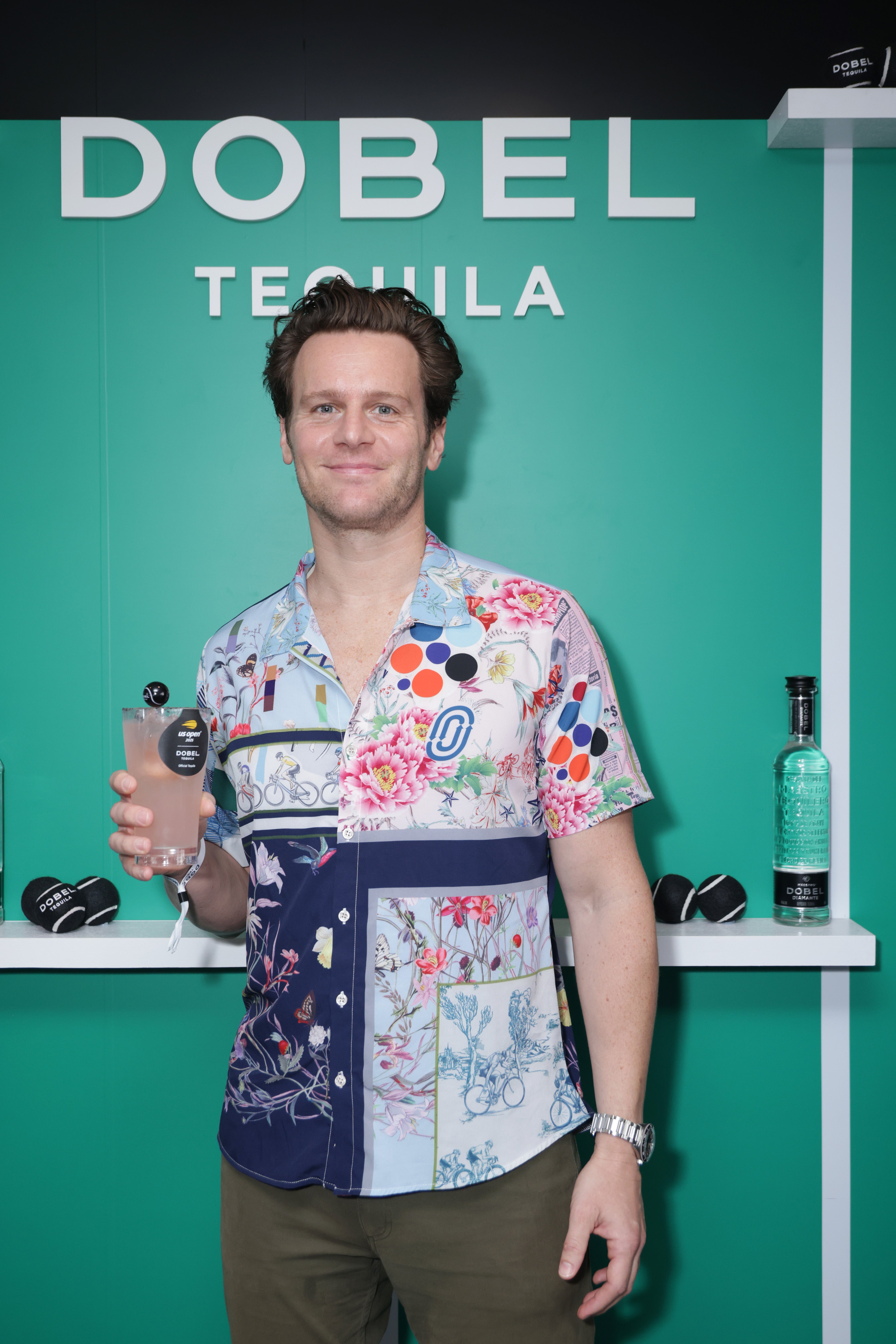 Actor Jonathan Groff wore a colorful button-down shirt and dark green pants at the US Open on August 25. However, there were too many different designs on the shirt that looked out of place