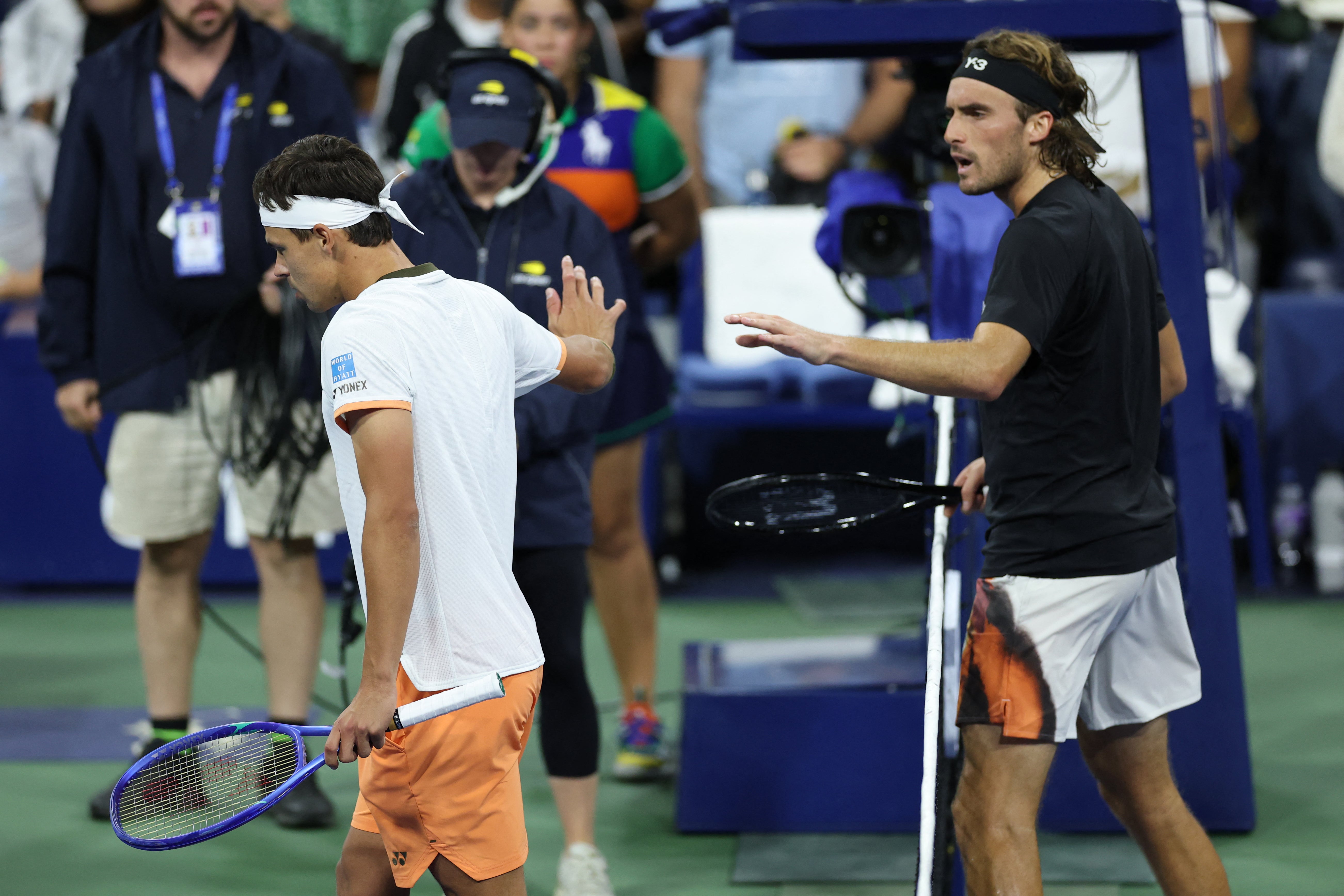 Daniel Altmaier and Stefanos Tsitsipas argue after shaking hands at the net