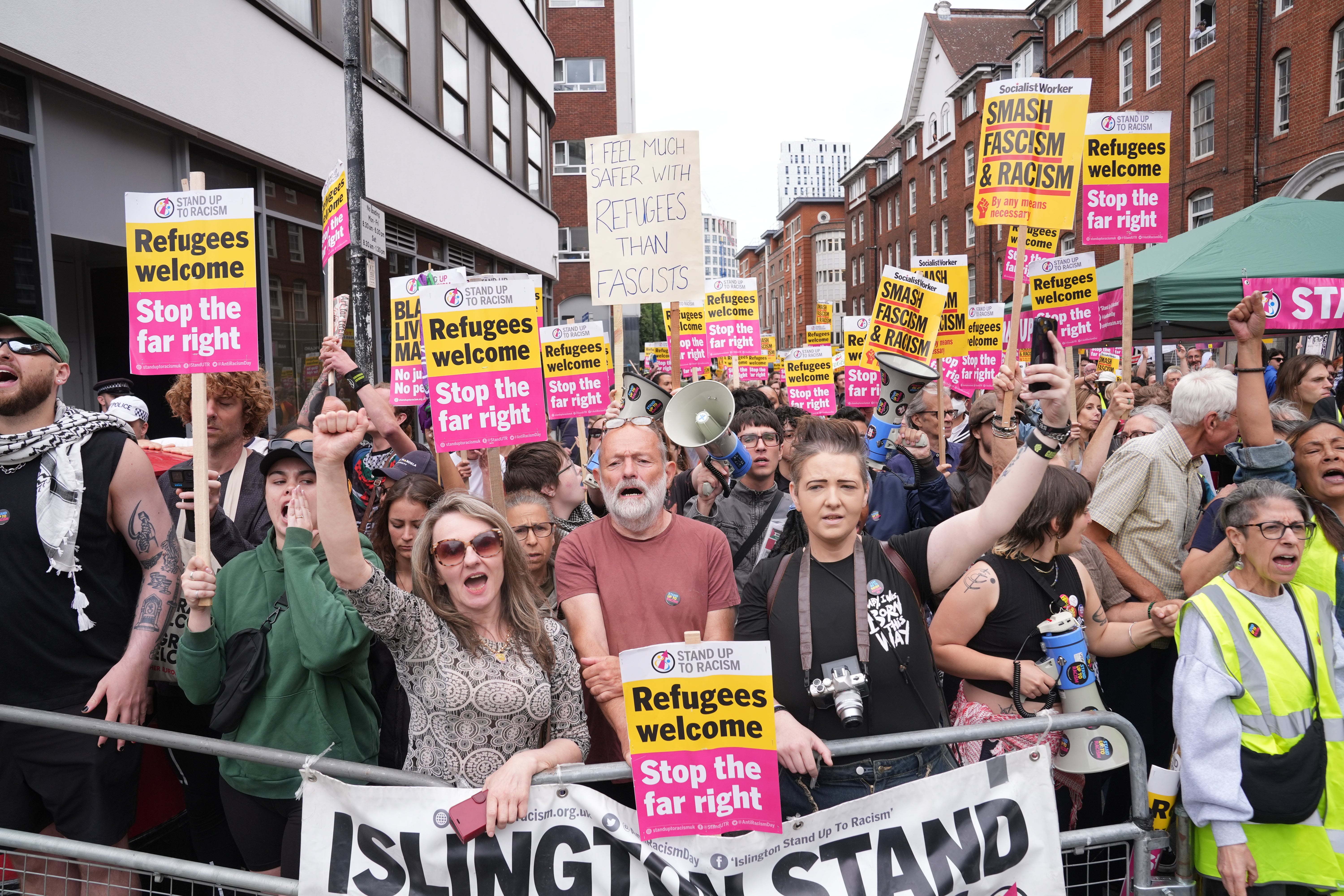 Protesters with Stand Up To Racism gather outside an asylum hotel in central London