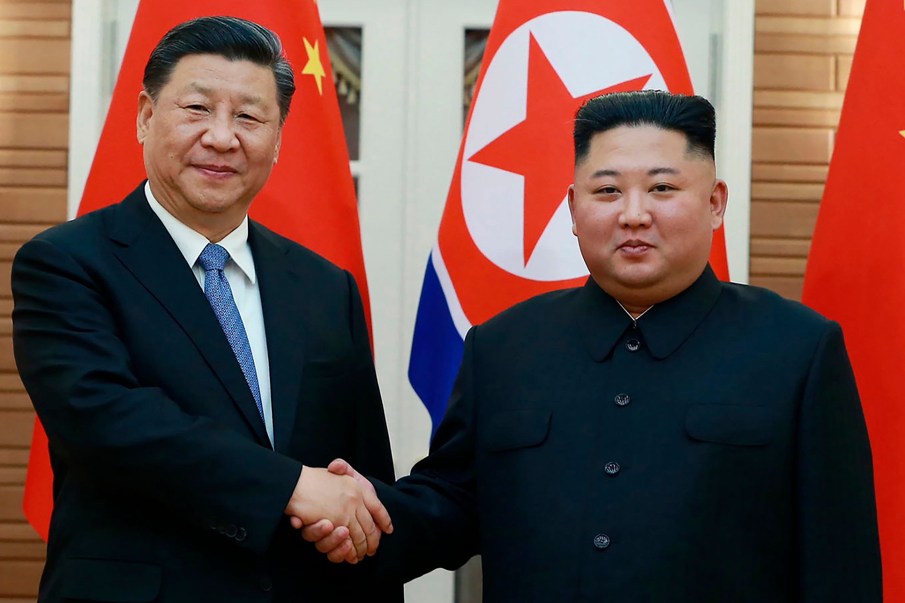 FILE - In this June 20, 2019, file photo provided by the North Korean government, North Korean leader Kim Jong Un, right, poses with Chinese President Xi Jinping for a photo at Kumsusan guest house in Pyongyang, North Korea