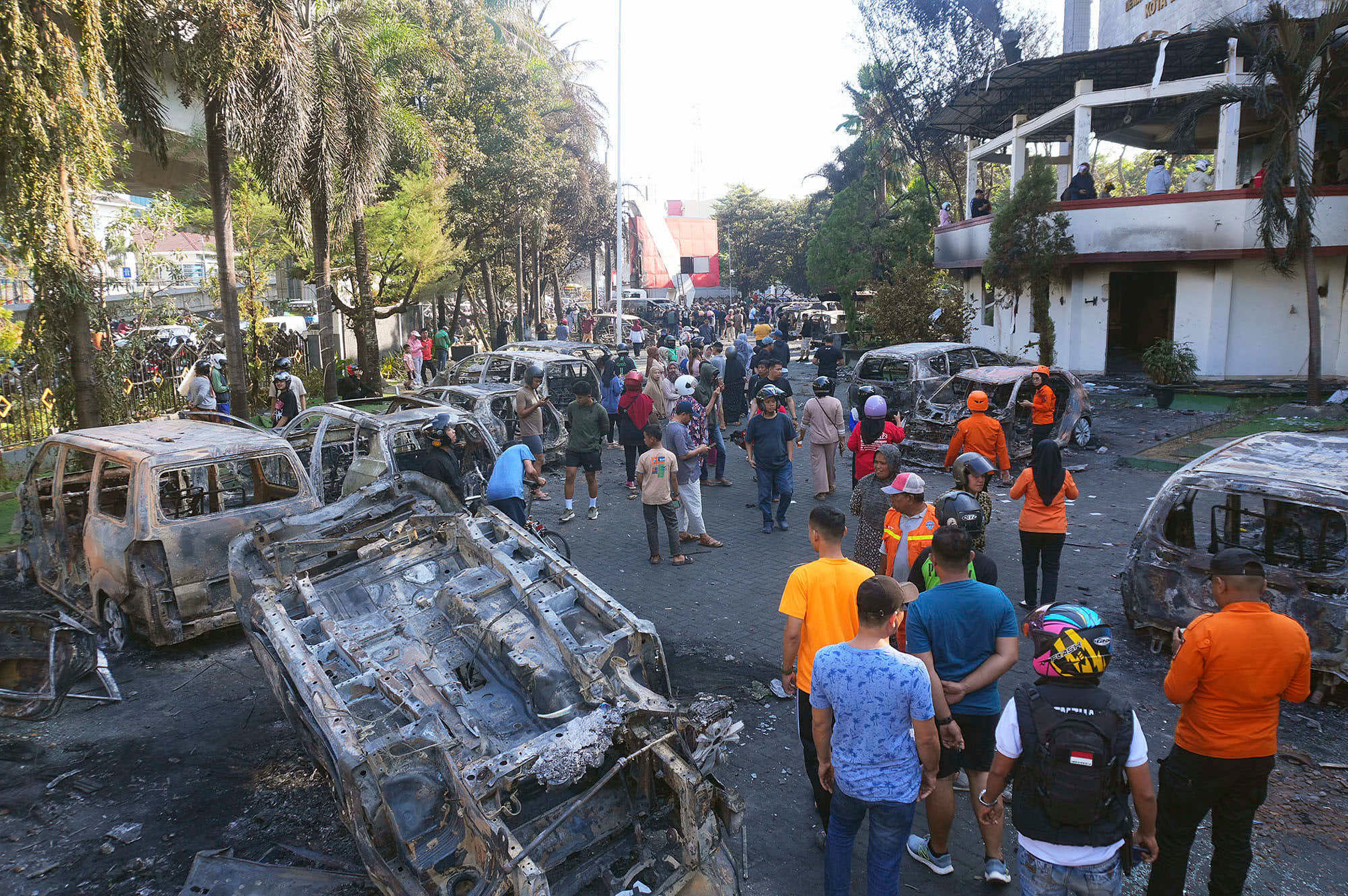 People inspect wreckage of cars burned during a protest against lavish allowances given to lawmakers in Makassar, South Sulawesi, Indonesia, on 30 August 2025