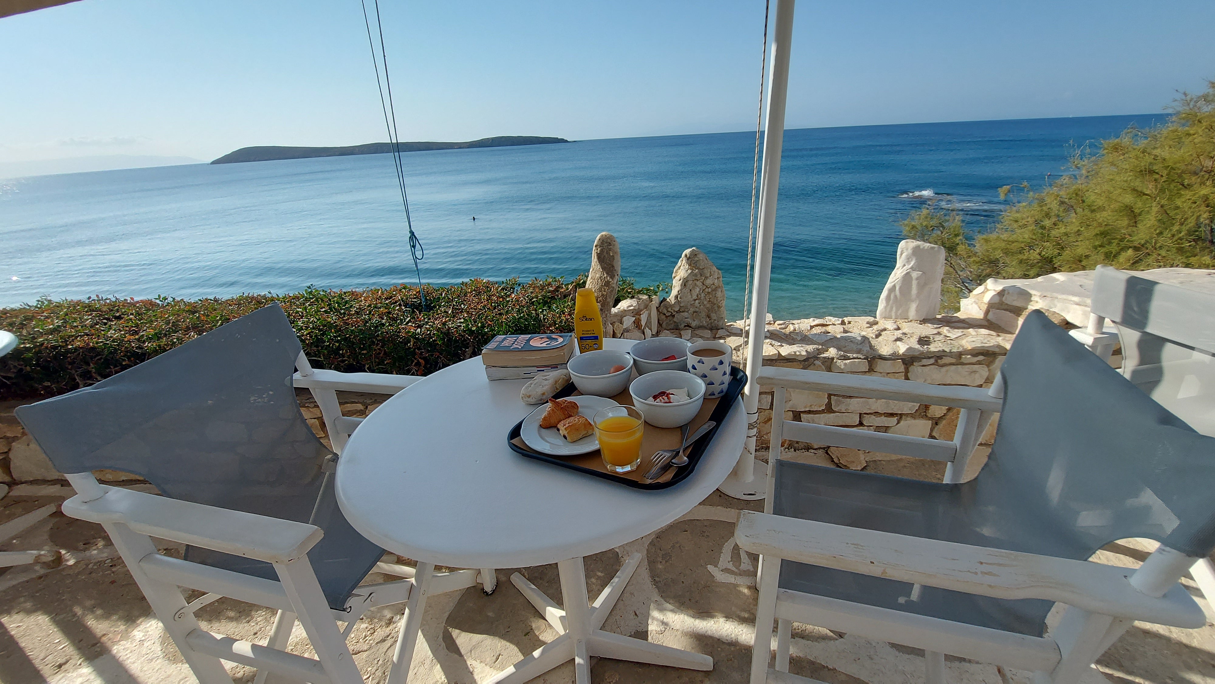 Ted and his family, along with a troupe of friends, stay in the 'excellent' Nissiotiko Hotel in the fishing village of Dryos. Above, Ted's sea-view breakfast set-up at the property