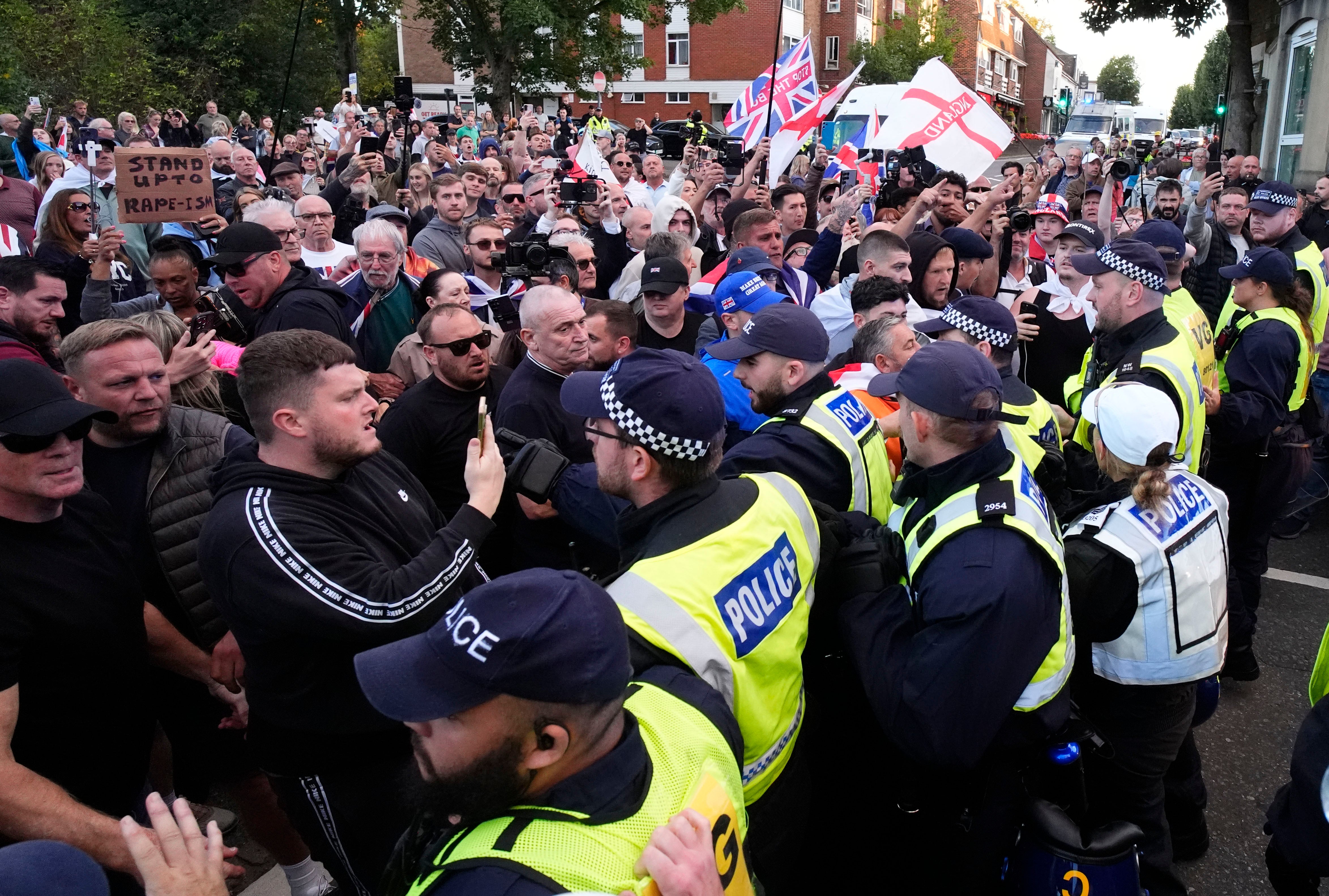 Demonstrators protest to stop a police van leaving after a protester was detained by police in Epping, Essex after a temporary injunction that would have blocked asylum seekers from being housed at the Bell Hotel, was overturned at the Court of Appeal