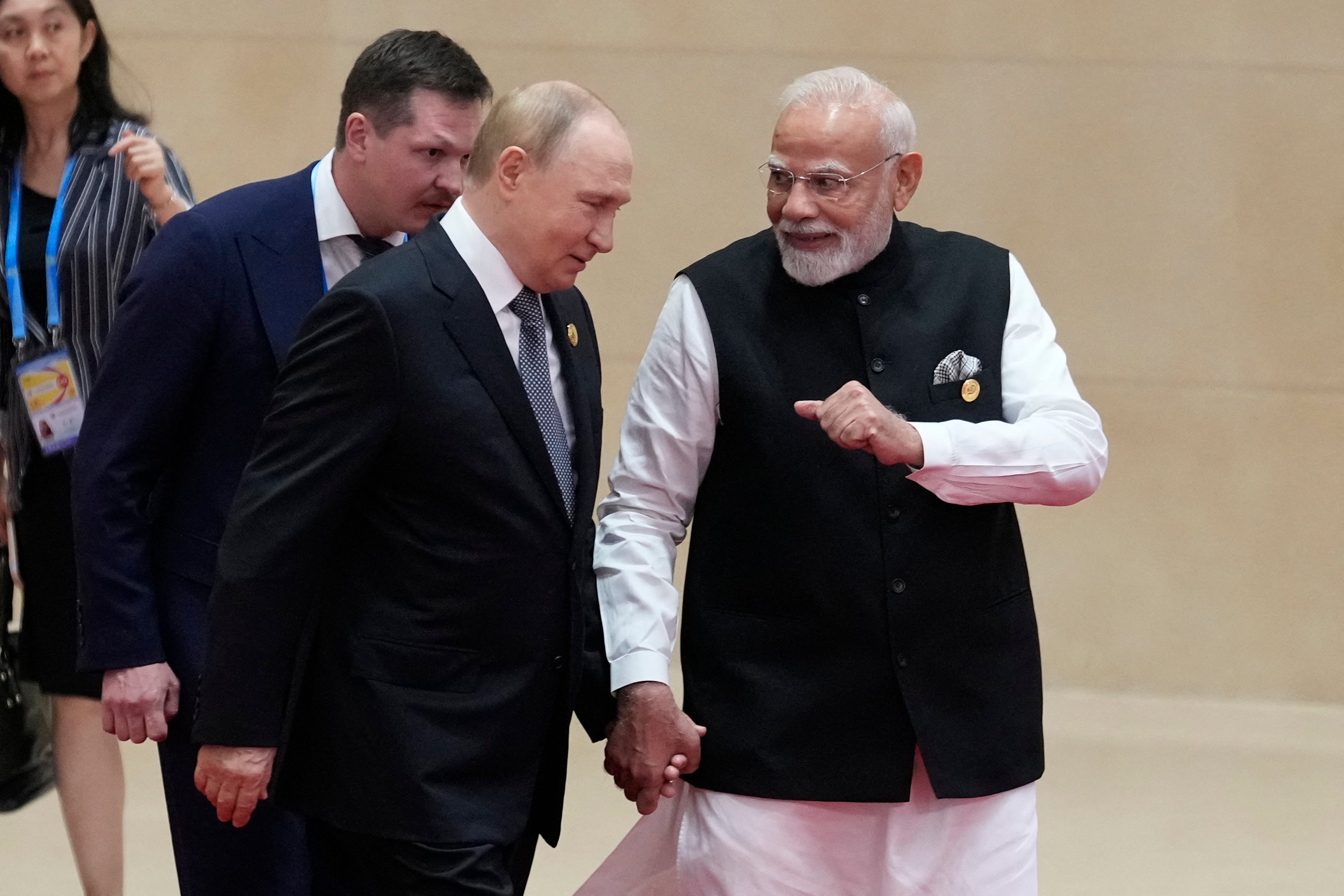In a display of solidarity, Putin and Modi walked hand-in-hand toward Xi before the summit opened