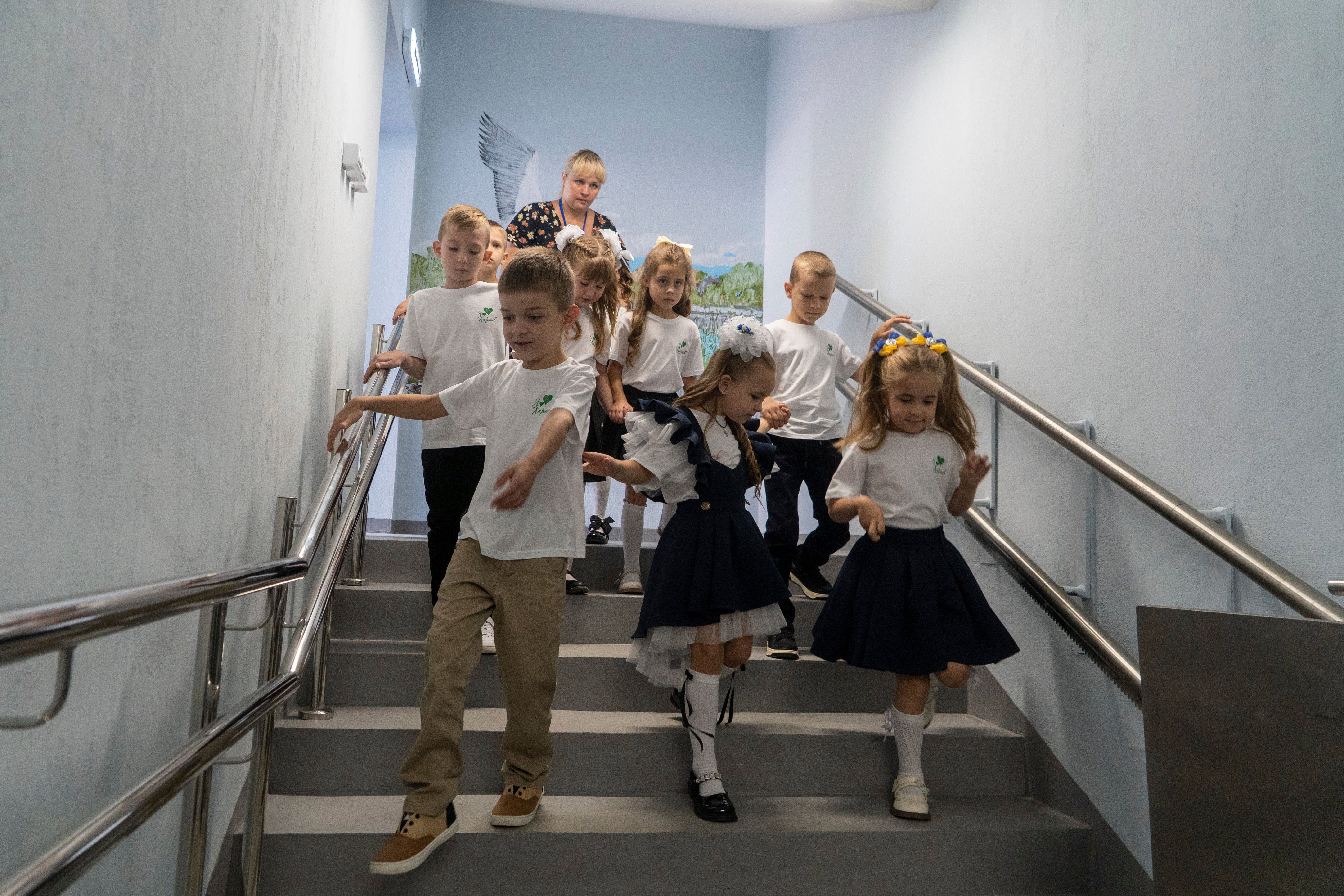 Schoolchildren enter an underground school on the first day at school in Kharkiv, Ukraine
