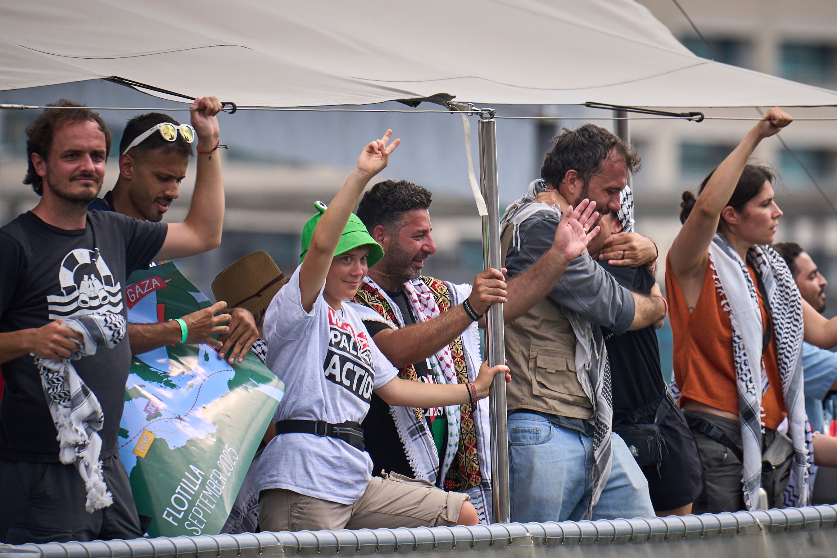 Swedish climate activist Greta Thunberg waves from a boat taking part in a civilian flotilla bound for Gaza
