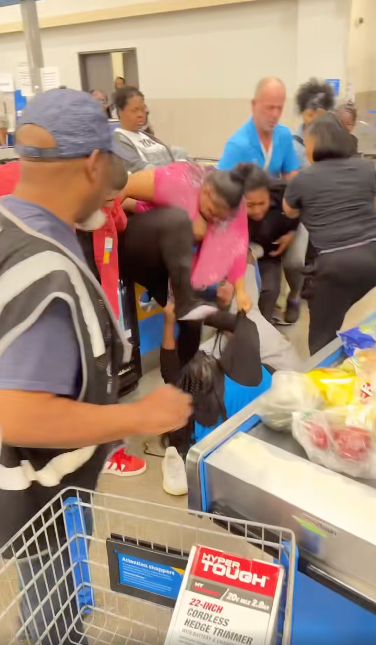 A woman wearing pink was filmed stamping on Hicks repeatedly