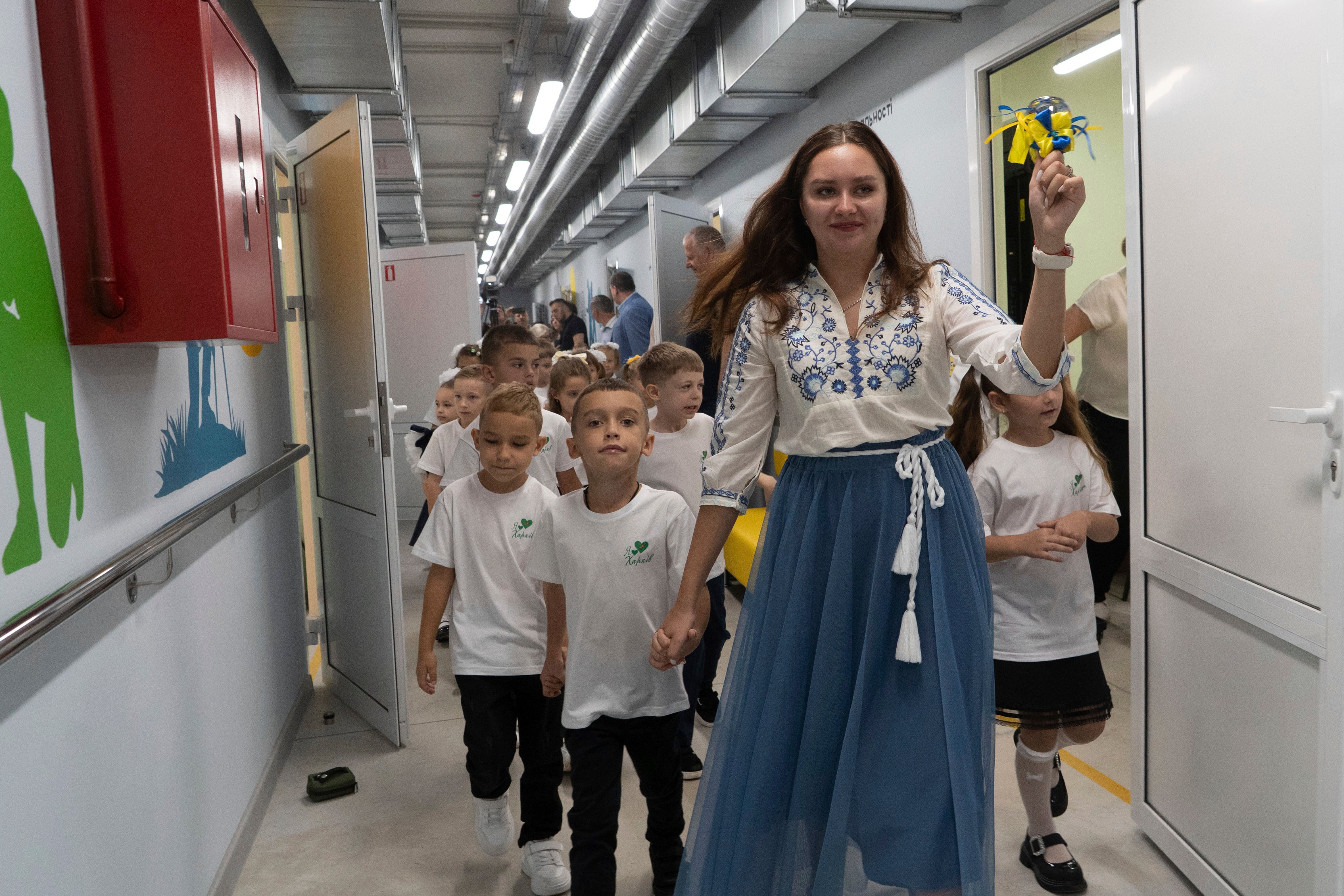 A teacher rings the bell on the first day in an underground school in Kharkiv, Ukraine