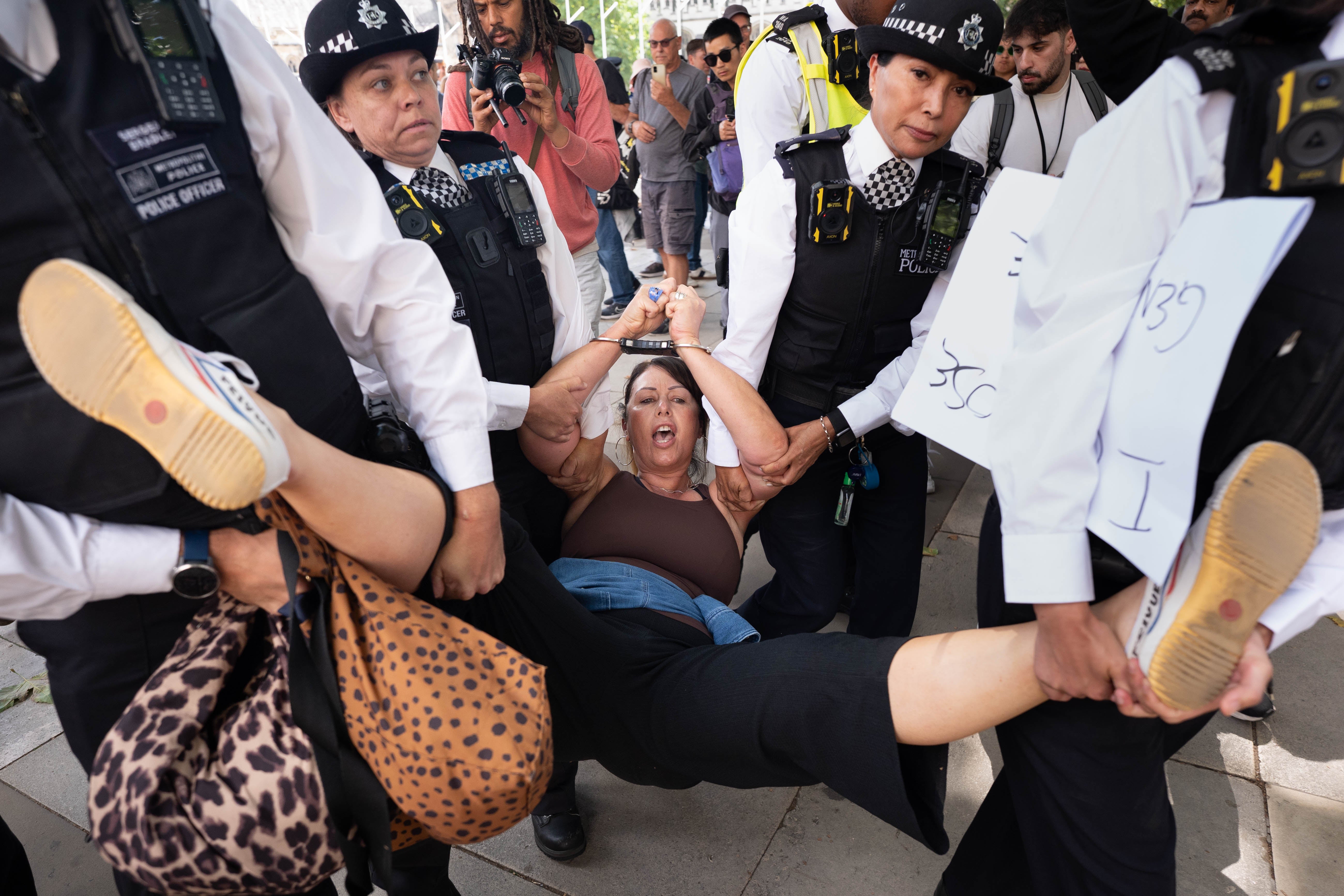Police arresting a Palestine Action campaigner in Parliament Square last month