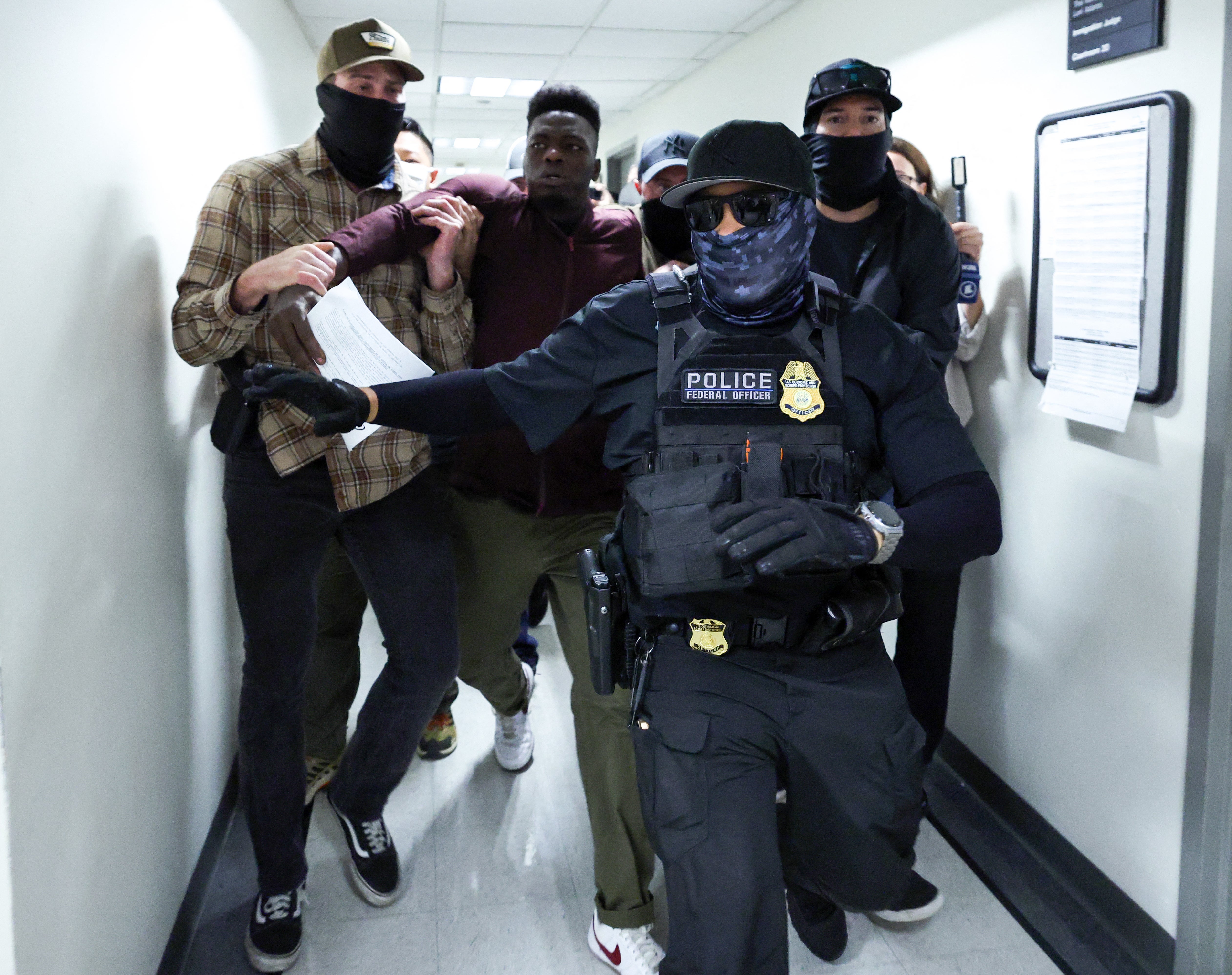 A federal judge has temporarily blocked the Trump administration from fast-tracked deportation proceedings that have sparked chaotic scenes of arrests inside immigration courts across the country.