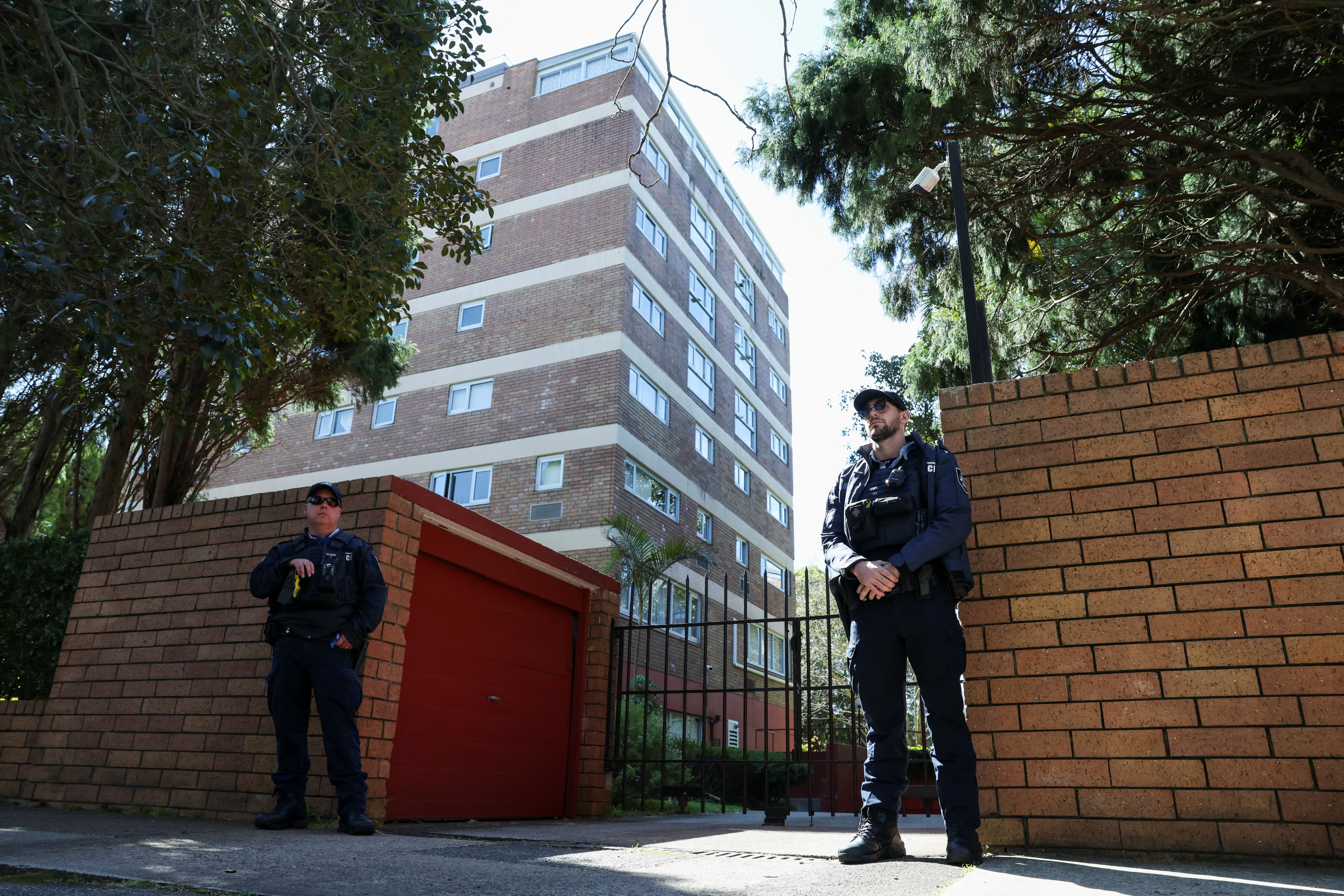 Police officers stand at the scene after a car crashed into the Russian consulate in Sydney, Australia, 1 September 2025