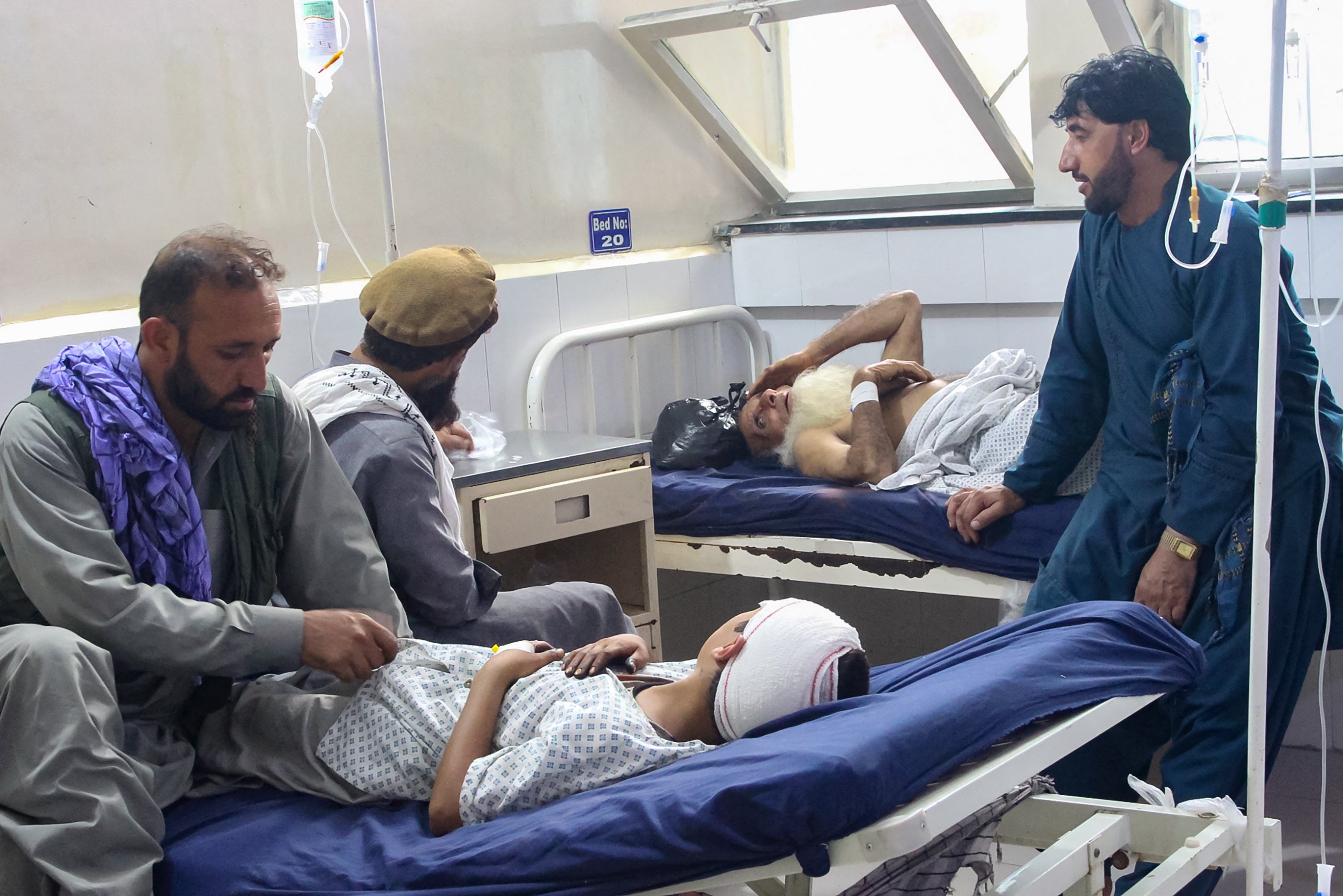 Injured Afghans receive treatment at a hospital in Jalalabad