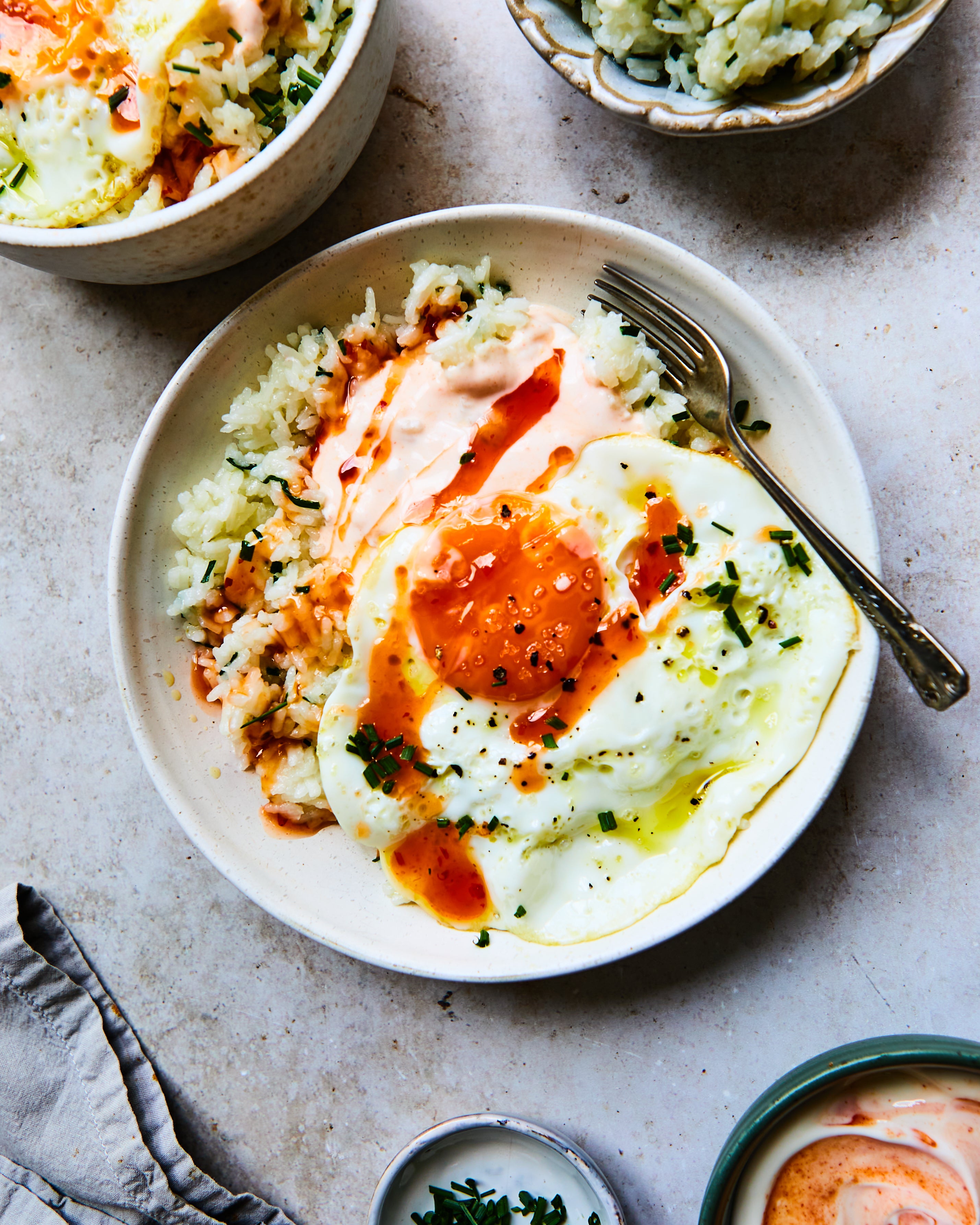 A grain bowl worth getting out of bed for – crispy eggs, fiery yoghurt and fluffy rice prove breakfast doesn’t need toast to shine