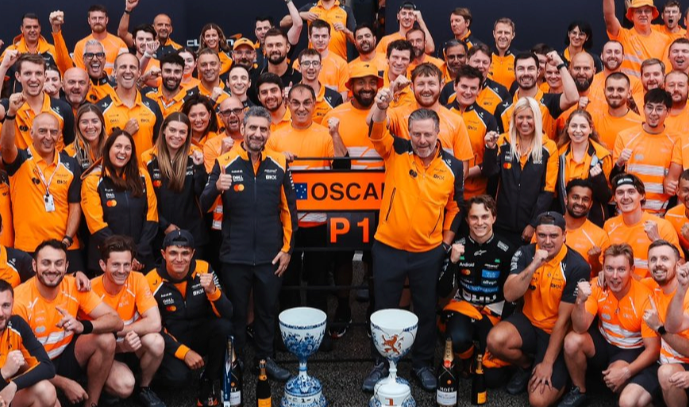 Norris (bottom-left) was present for McLaren's race-winning photo after Piastri's victory