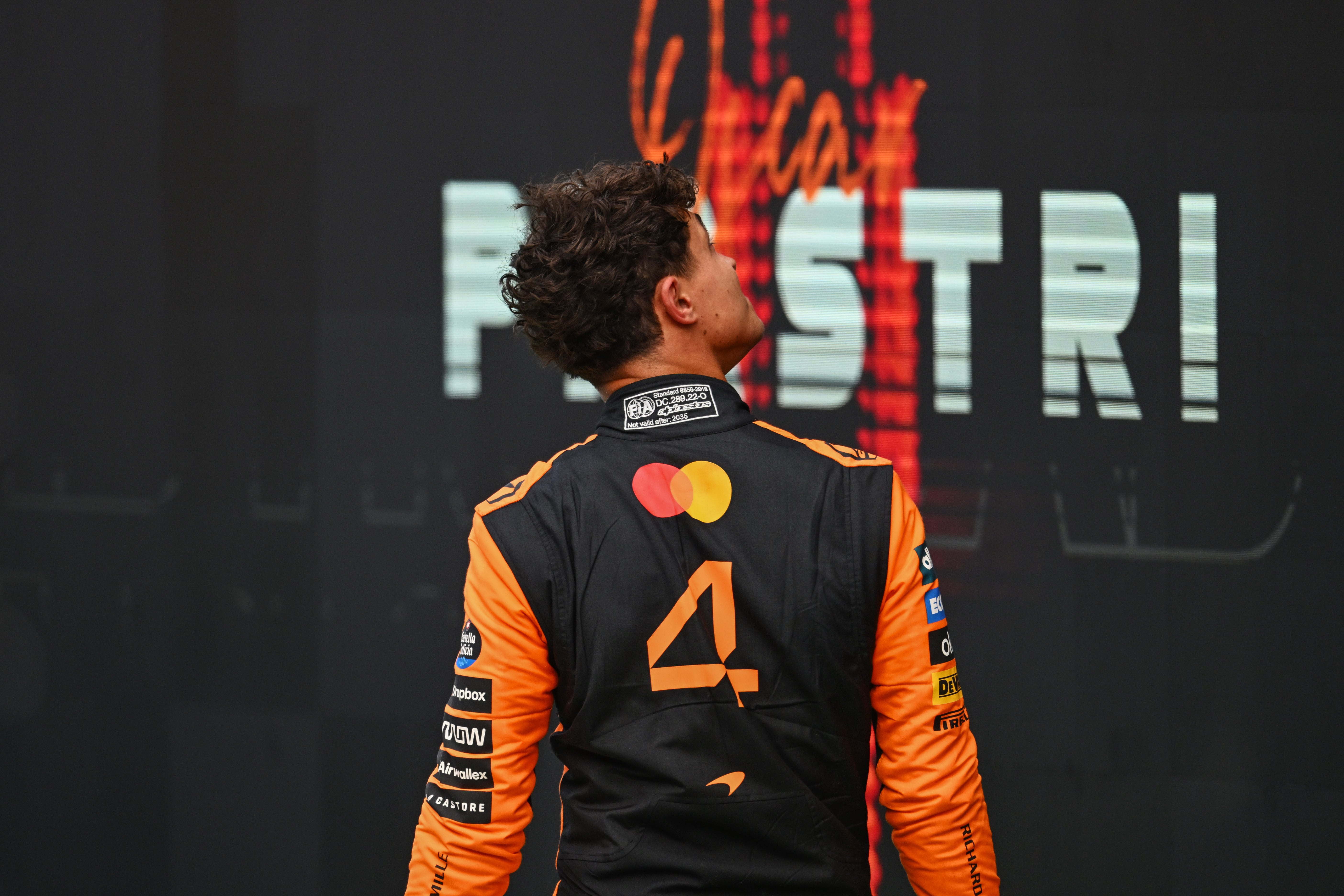 Lando Norris looks up as Oscar Piastri walks onto the top step of the podium in Zandvoort