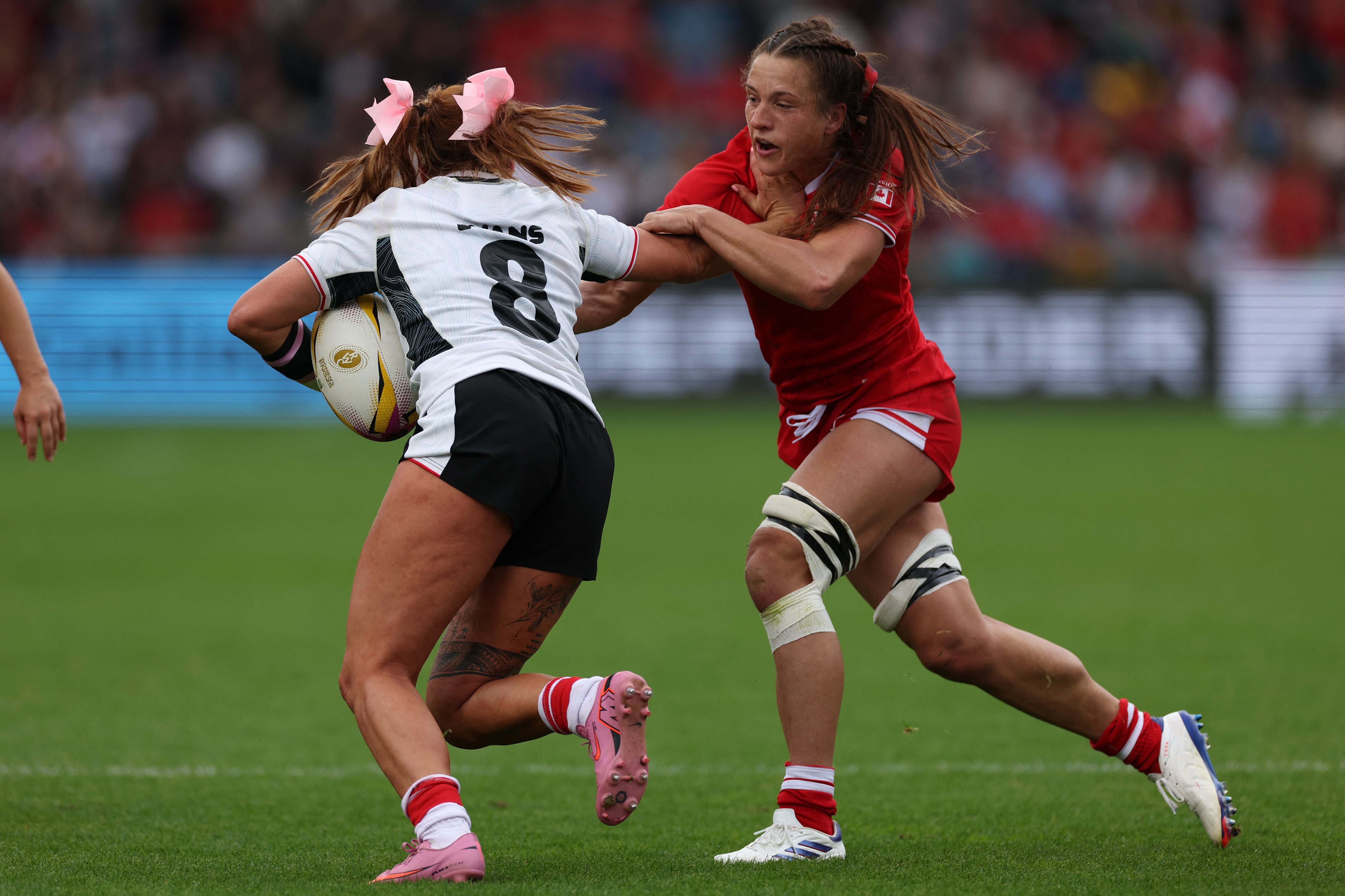 Georgia Evans (left) sported her trademark ribbons in her hair in Wales's defeat to Canada