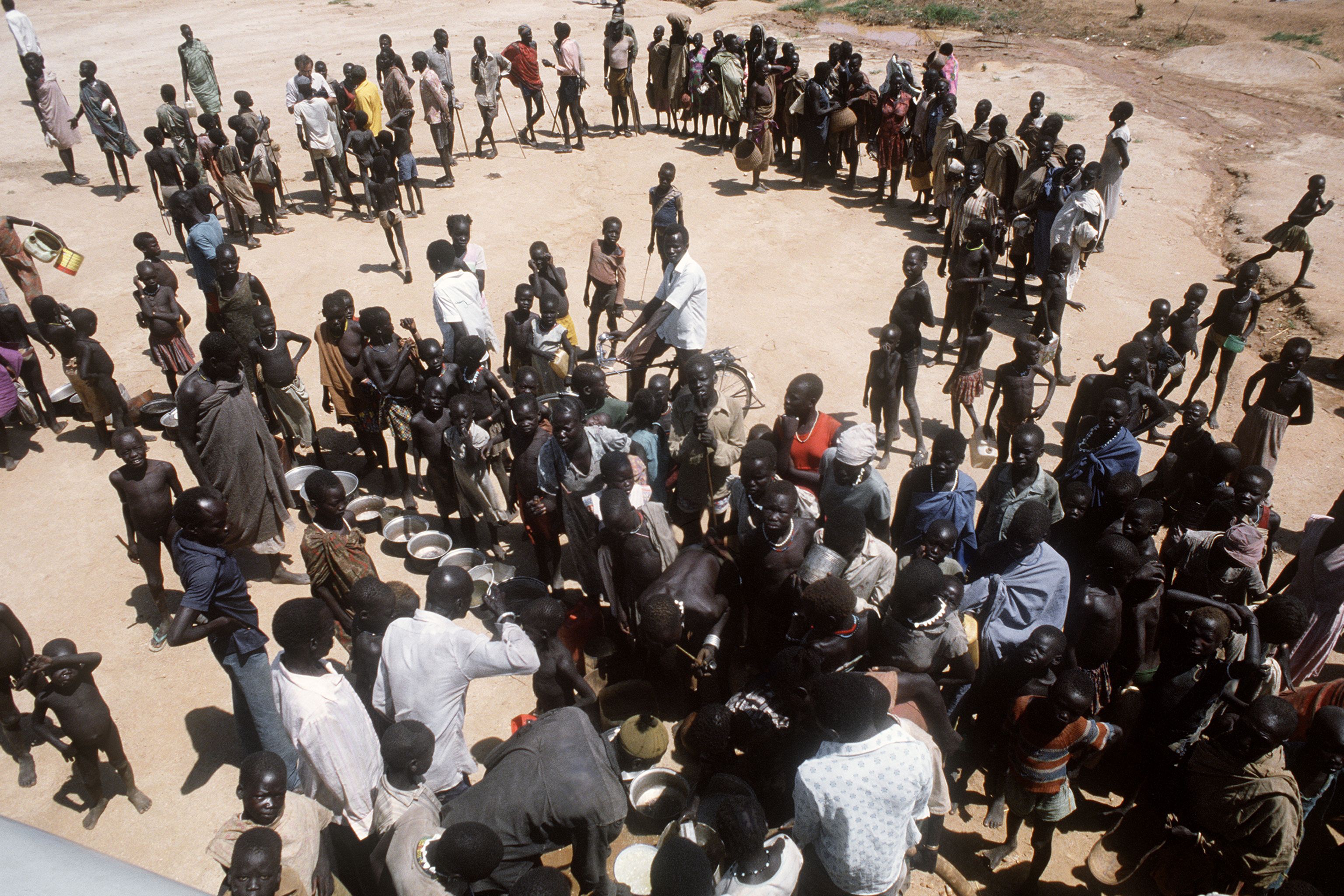 Sudanese citizens standing in a refugee camp, circa 1980s
