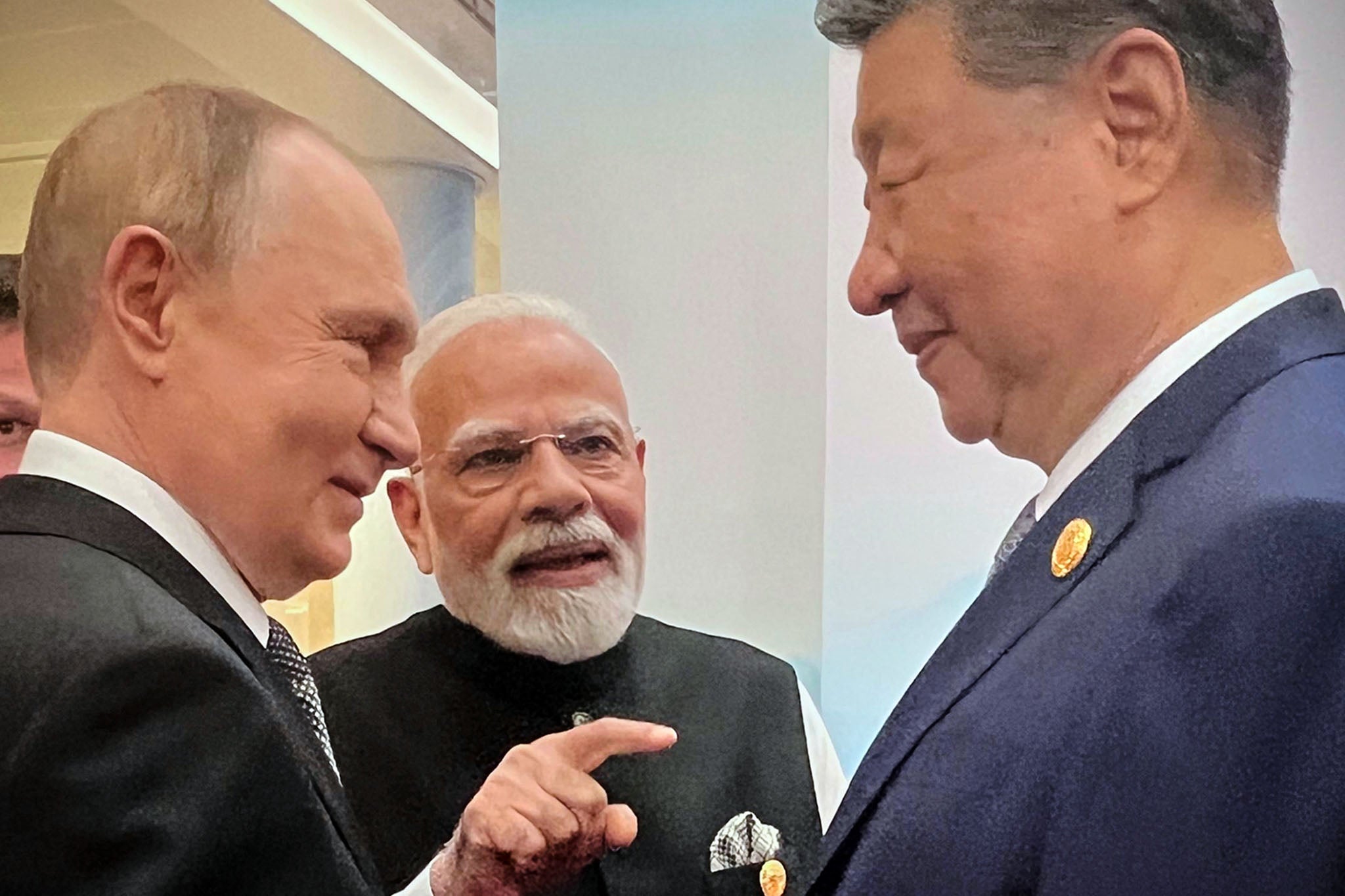 Putin, Narendra Modi and Xi Jinping talking ahead of their summit in Tianjin, China, on Monday