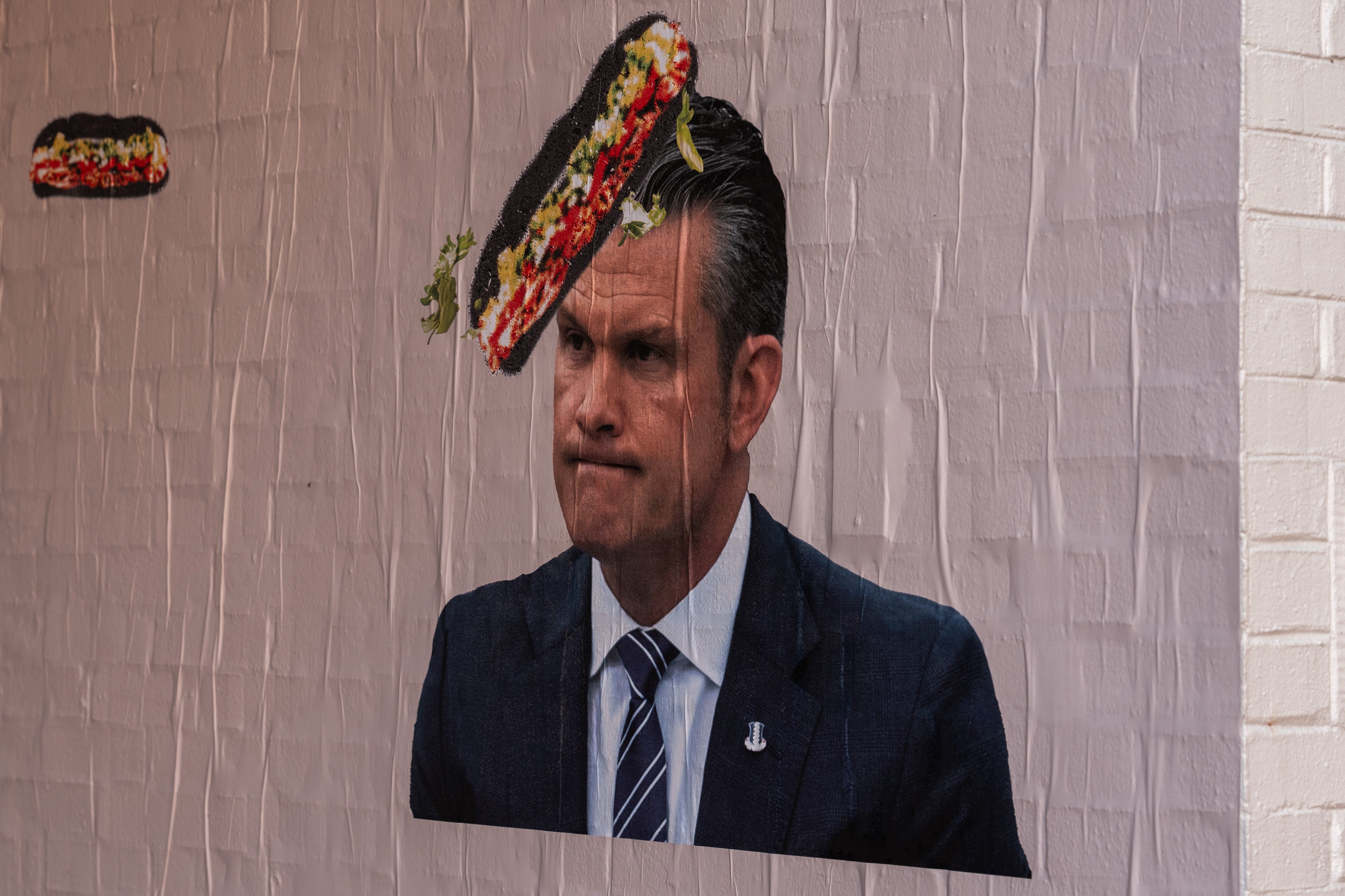Posters showing Pete Hegseth and Stephen Miller being hit in head with hoagies from ‘sandwich guy’ protester pop up around DC