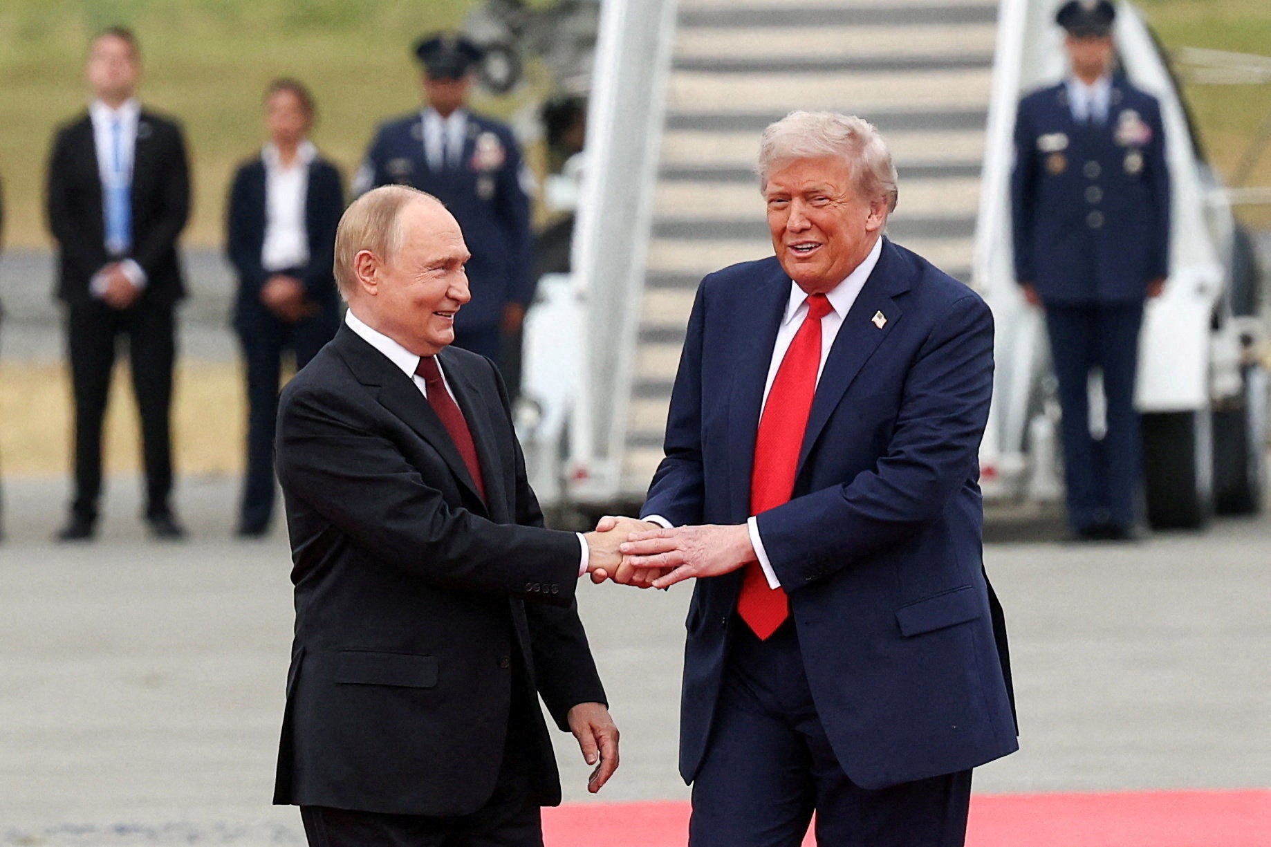 Donald Trump shakes hands with Vladimir Putin as they meet to negotiate for an end to the war in Ukraine in Alaska last month