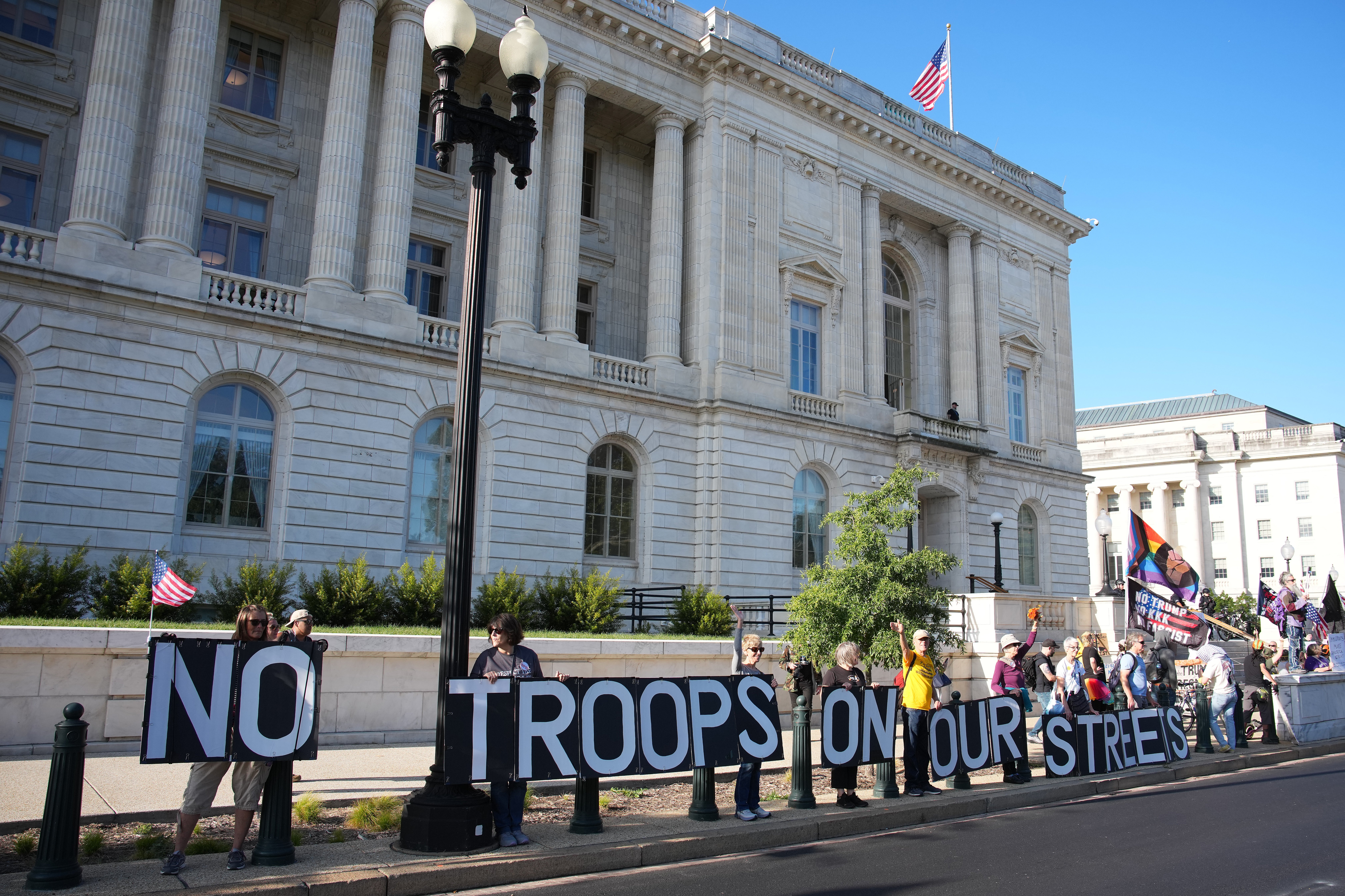 Protesters rally against National Guard deployment as they march on Capitol Hill