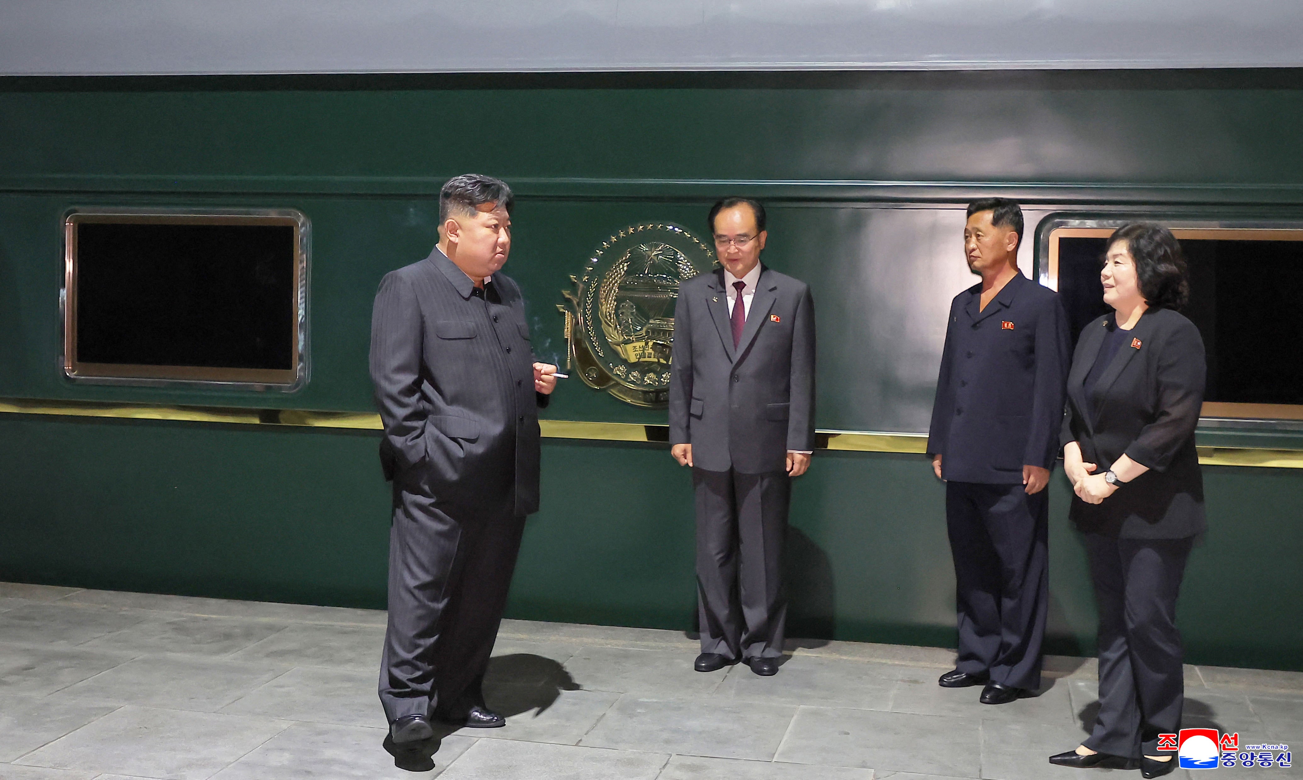 North Korea's leader Kim Jong Un (L) as he departs from Pyongyang by special train to visit China