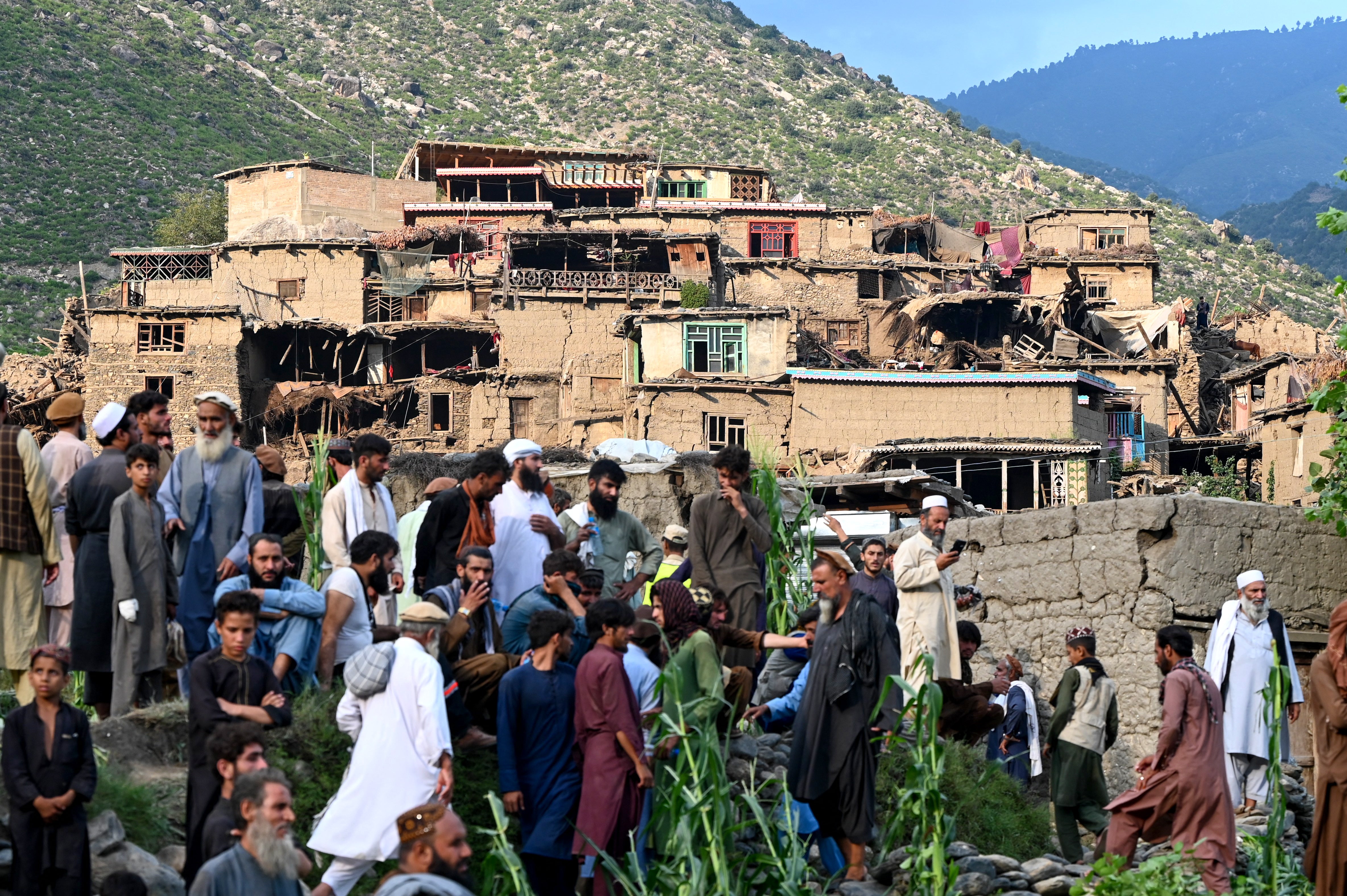 Afghans gather near damaged houses after an earthquake struck Mazar Dara village in Nurgal district of Kunar province on 1 September 2025