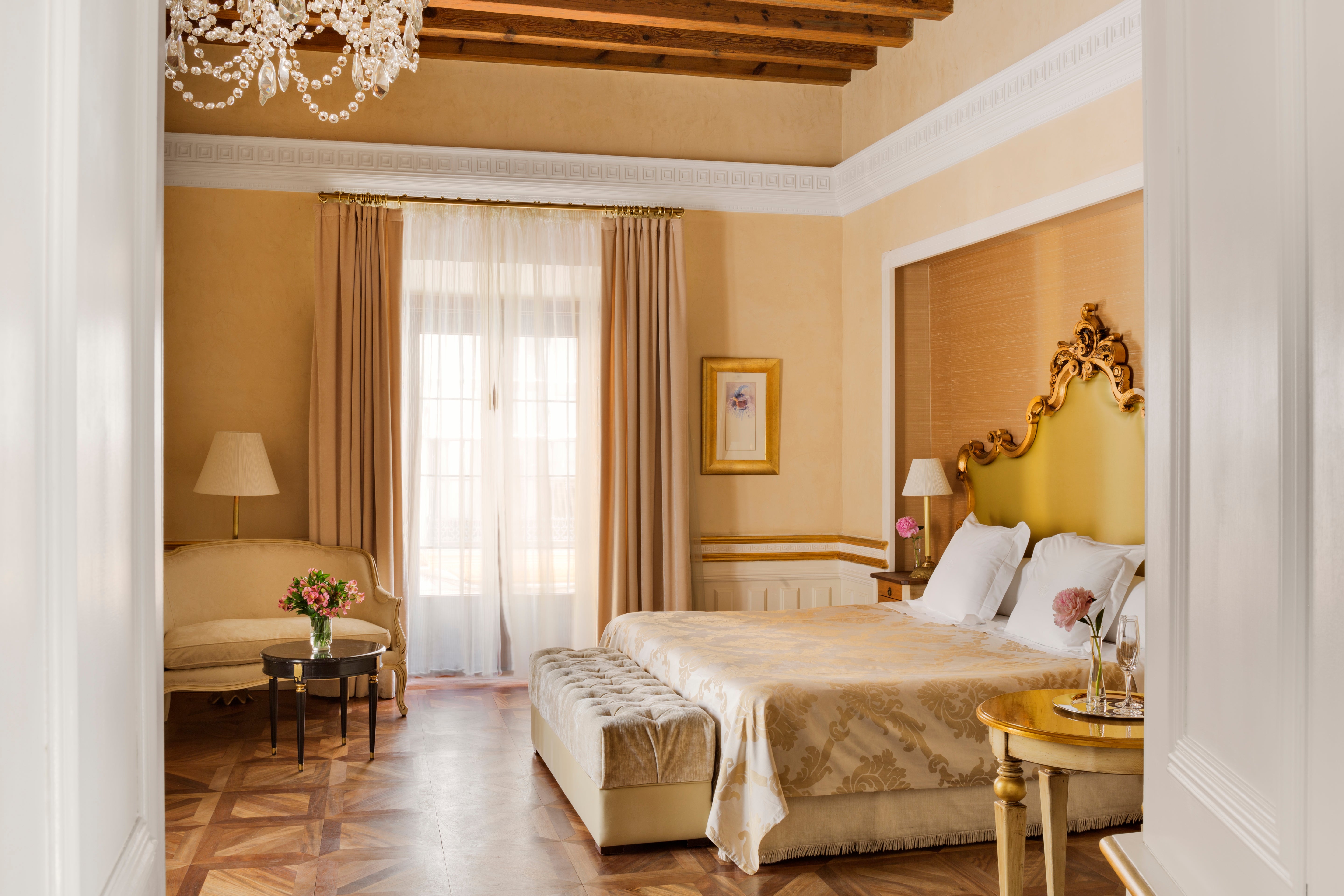 Golden headboards and brocade bedspreads give Casa 1800 a baroque vibe