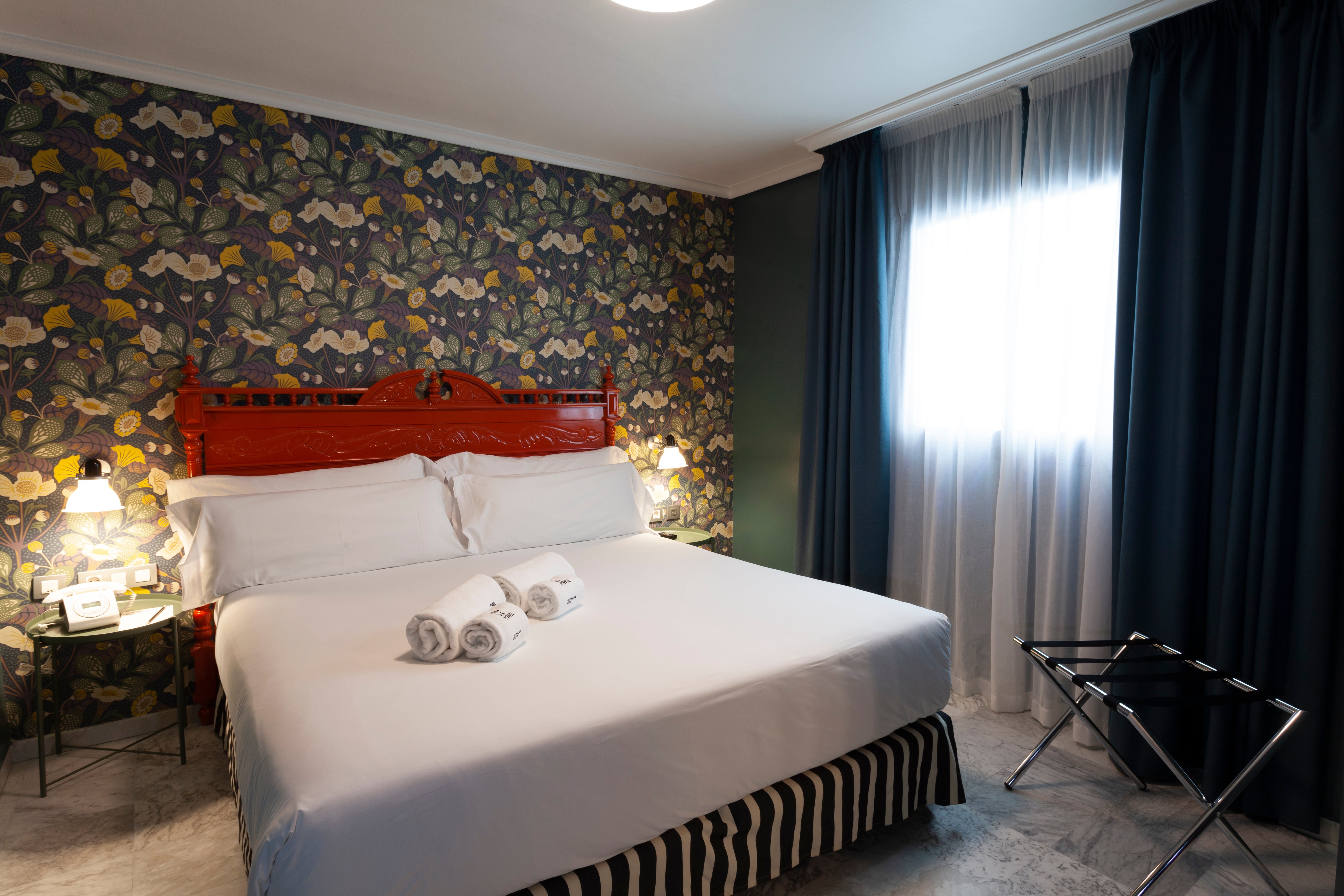 Bold red headboards and floral wallpaper can be found in the rooms at this hotel